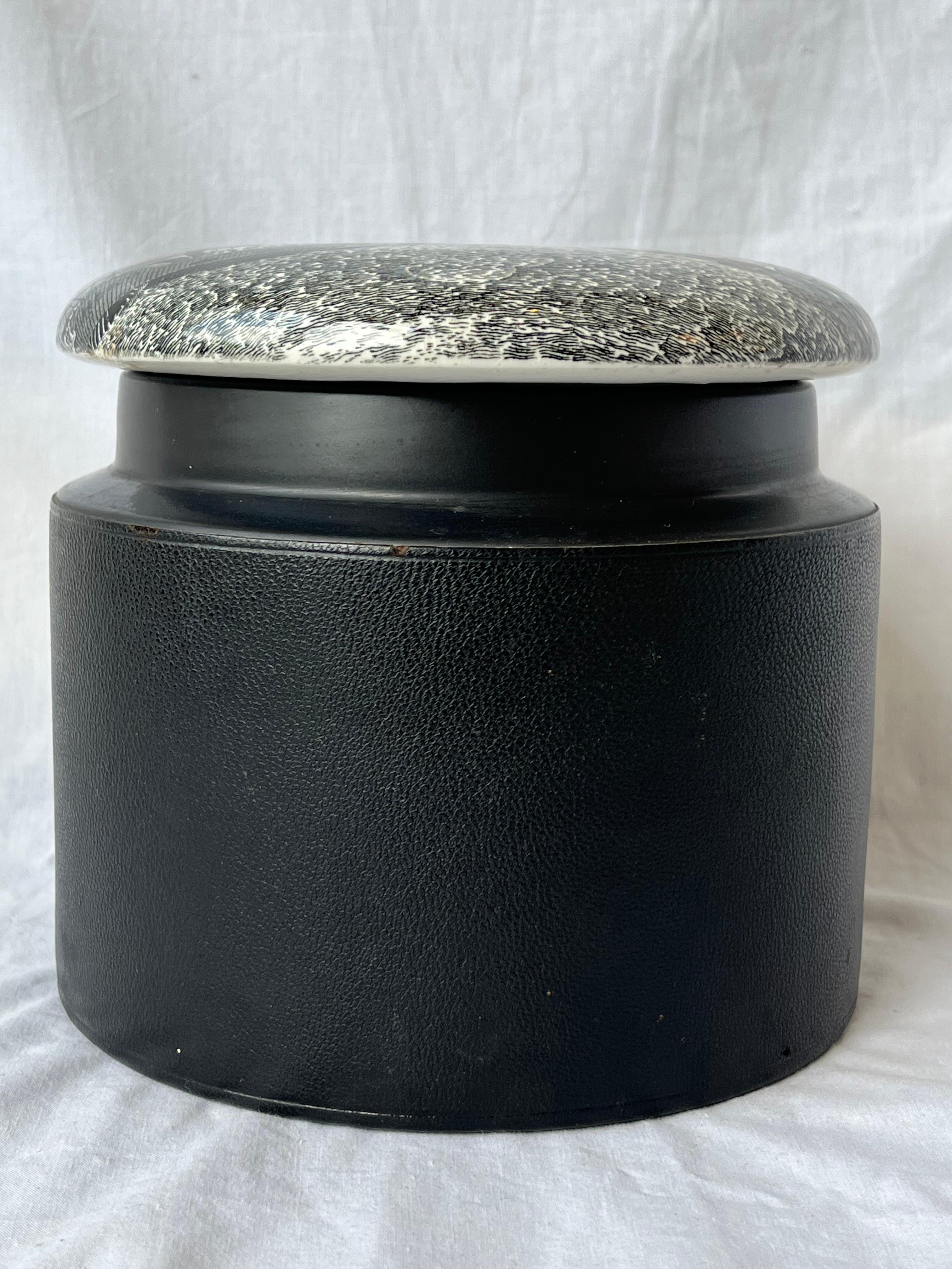 A vintage, 1970s era, lidded tobacco jar designed by Susan Williams-Ellis for Portmeirion and retailed through Comoy's of London. The lid is printed with a port scene. The body is wrapped in a textured leather. A little history of Portmeirion from
