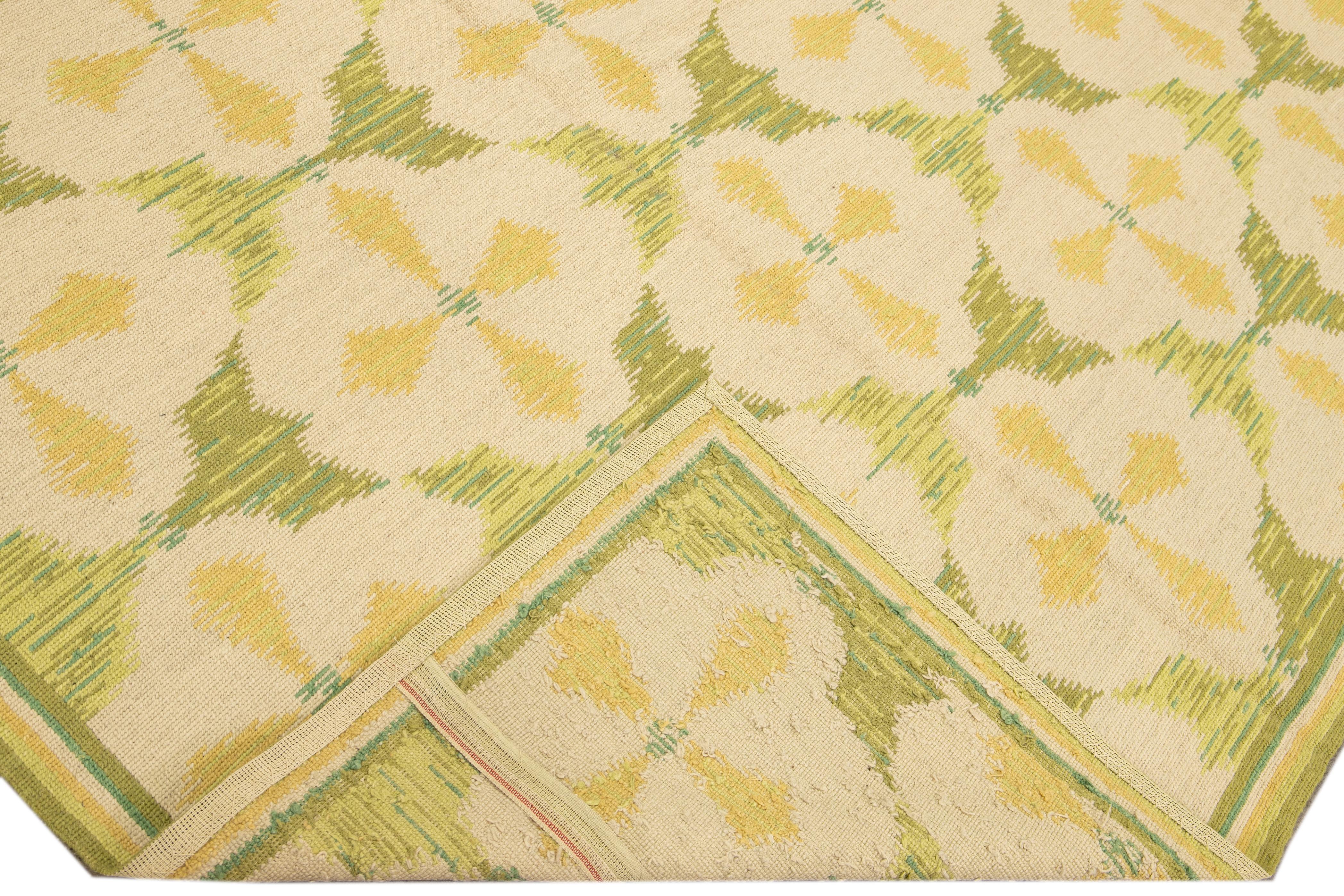 Beautiful vintage Portuguese Arraiolos needlepoint wool rug with a green field. This piece has fine details in a beige and yellow layout on a gorgeous floral pattern design. 

This rug measures: 8'11