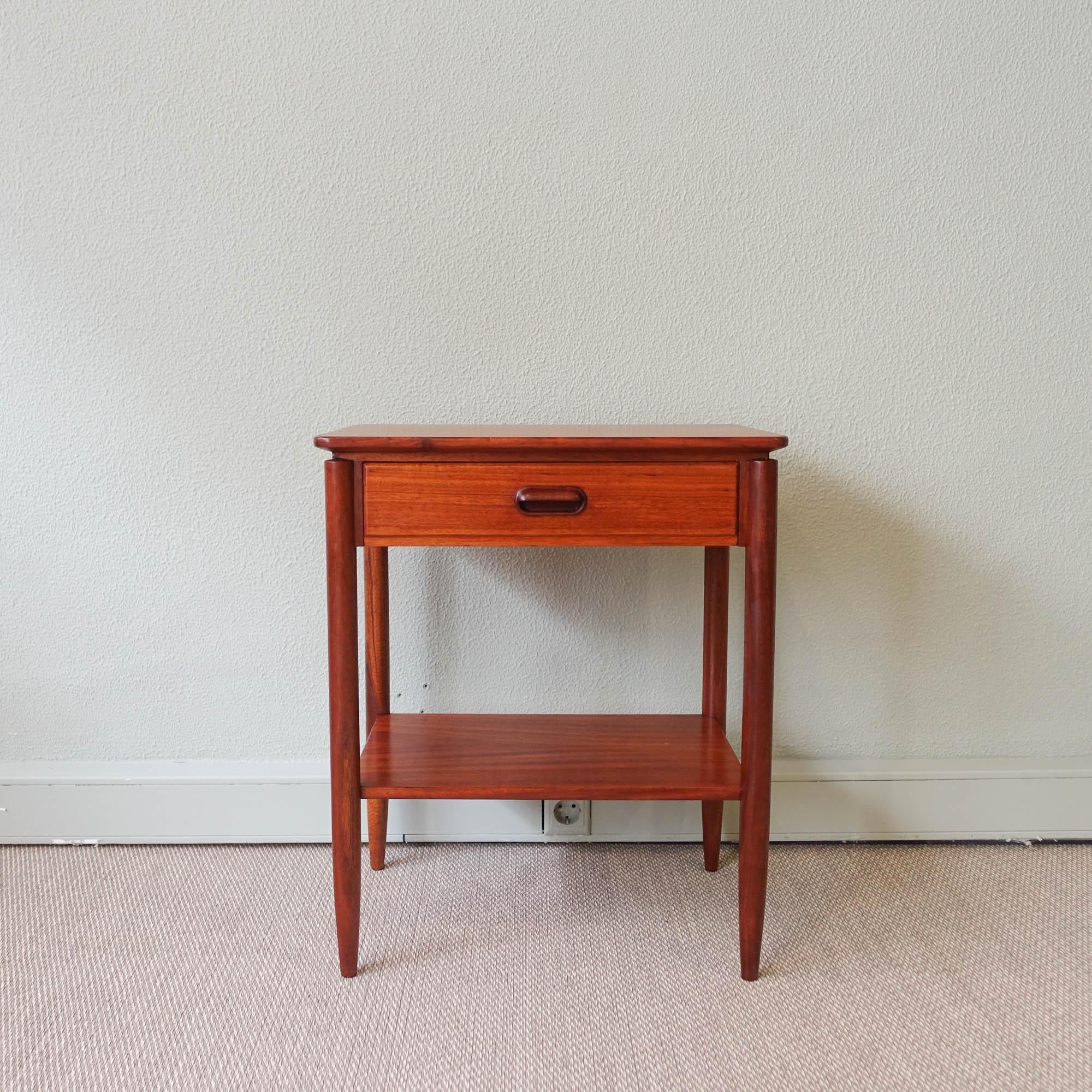 This bedside table was designed and produced by Móveis Olaio in Portugal during the 1960's. It is made of mutenye wood and features one drawer with a wood handle in a darker wood. It was completely restored.