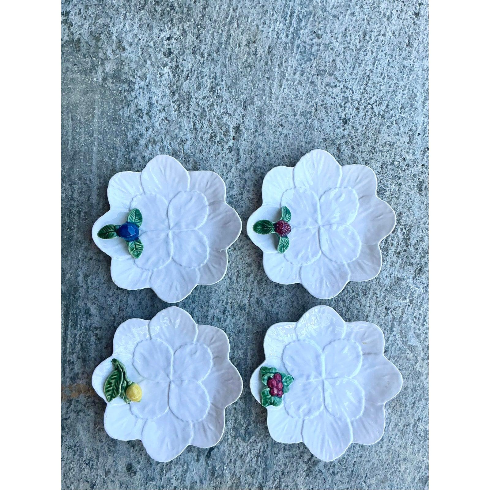 Serve in style with this delightful set of four vintage appetizer plates from the esteemed Portuguese ceramic maker, Bordallo Pinheiro. Each plate is a miniature work of art, expertly molded and glazed to resemble a stylized leaf or flower petal