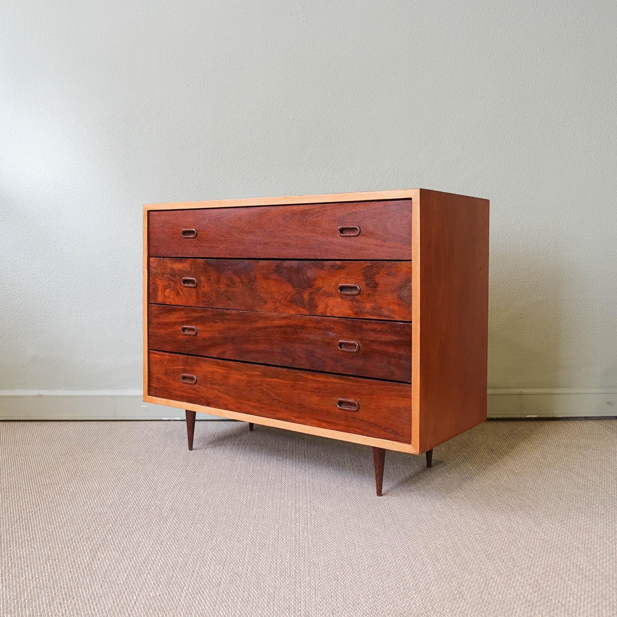 This chest of drawers was designed and produced in Portugal, during the 1950's. It is made of sucupira and agba wood with oval wooden handles. It features four big drawers in total. In original condition, with a deep wood cleaning.