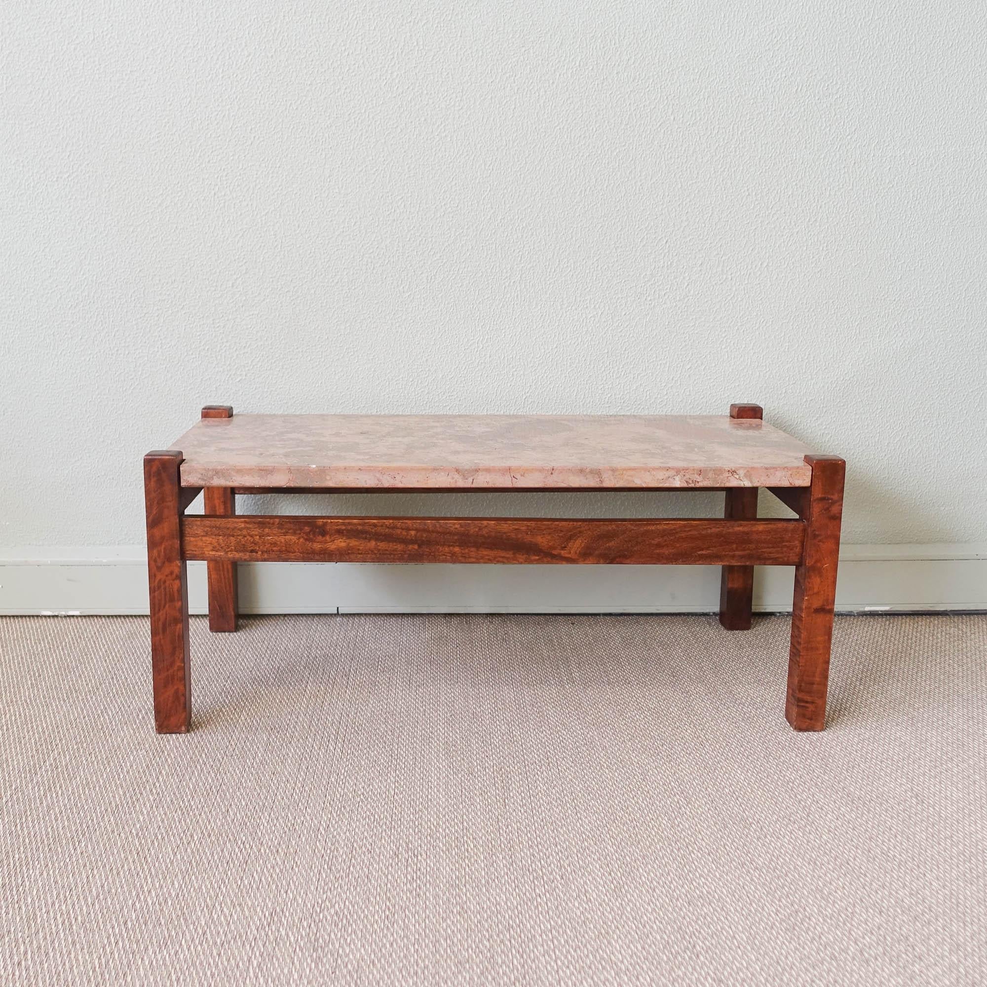 This coffee table was designed and produced in Portugal, during the 1970's. The structure is made of solid wood and the top is in Cascais Limestone. It is in good and original condition.