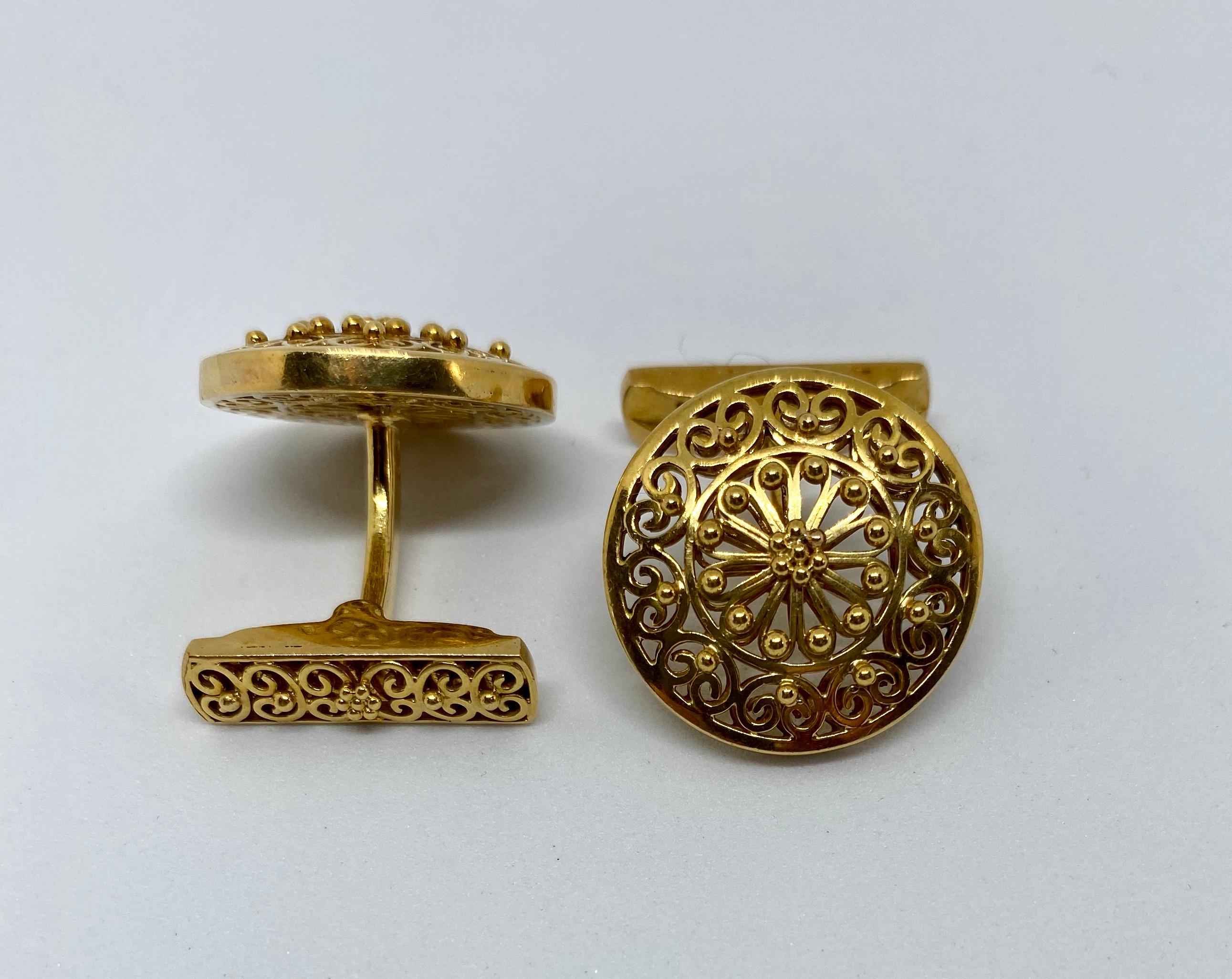 Spectacular vintage cufflinks made in Portugal, where the gold standard is higher than the rest of Europe, at .800 or 19.2 karat.

The workmanship is outstanding. The cufflinks feature openwork circles backed with matching openwork fasteners. Small