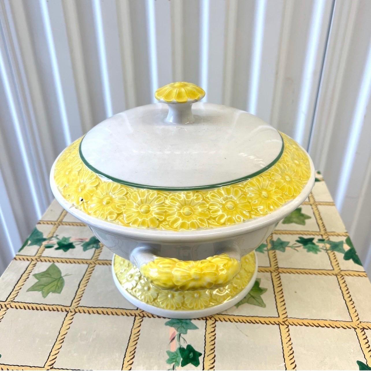 A fantastic vintage tureen with yellow daisies and green accents on the bottom, top and on the handles.  Marked “Made in Portugal”