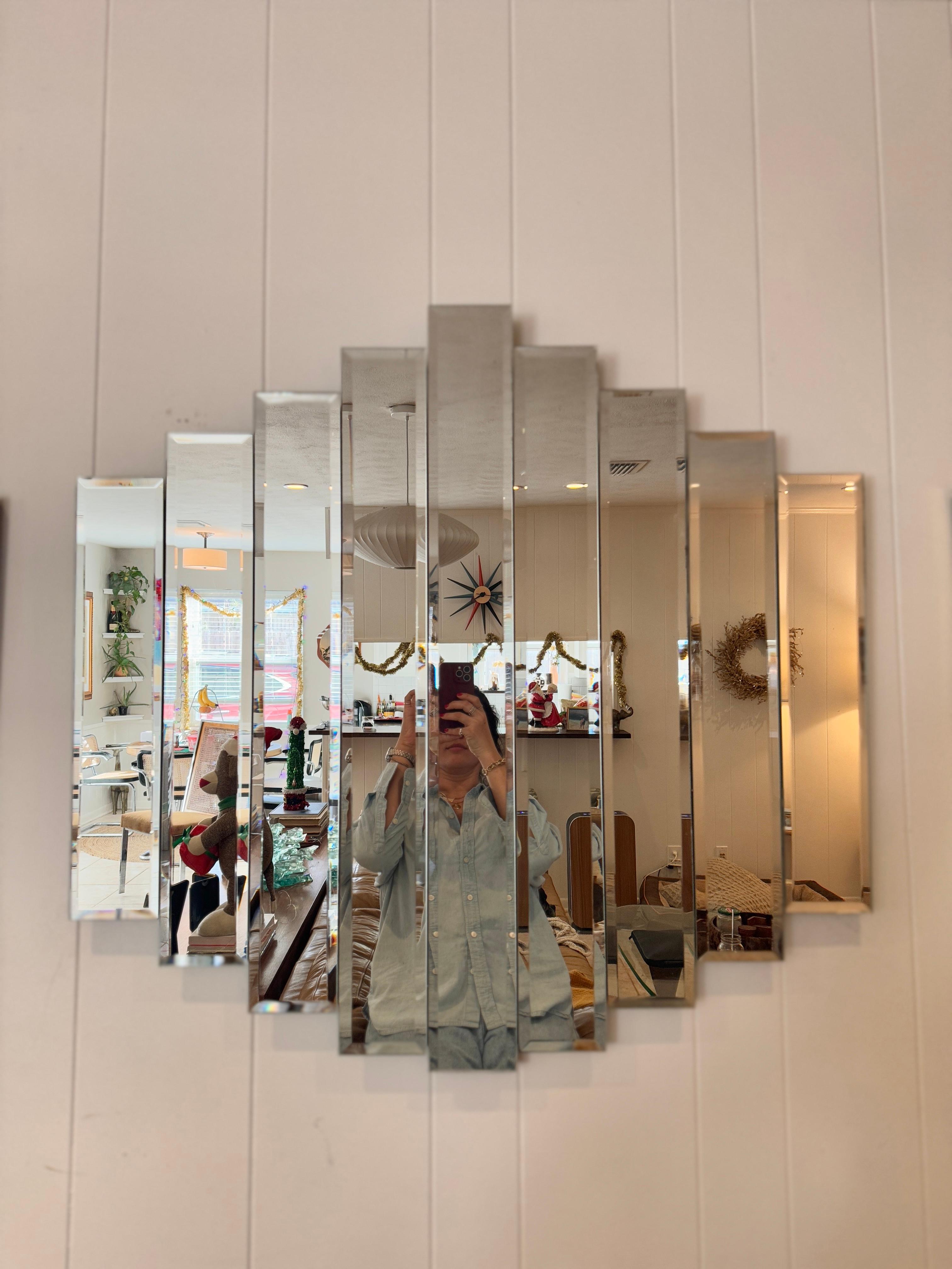 Vintage post modern 9 panel beveled cascade mirror, circa 1980s. The nine beveled panels cascade in a way that adds so much depth and dimension to a space. I love how the staggered design catches the light, giving it a unique and dynamic vibe. It’s