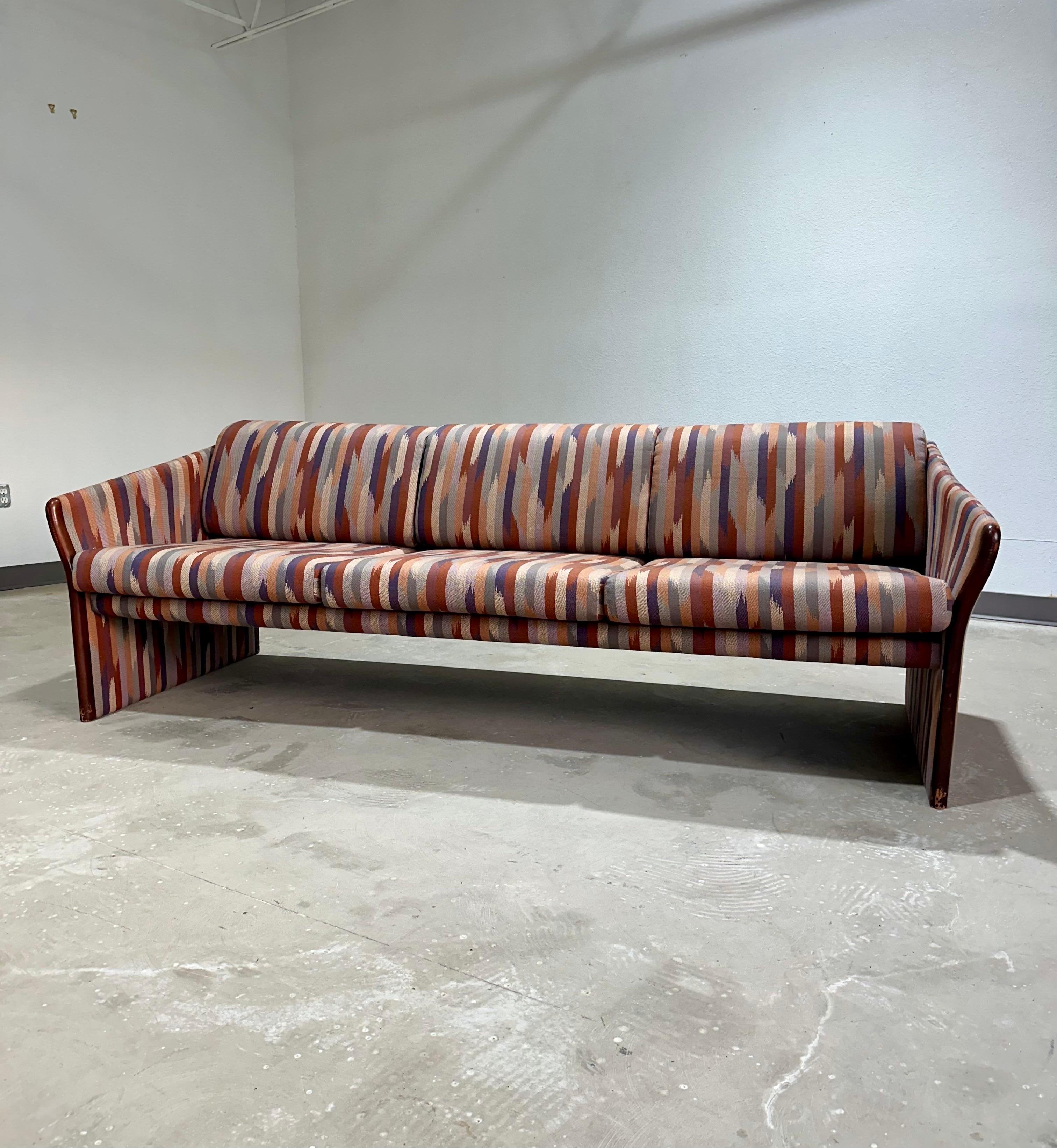 Vintage Postmodernist Sculptural sofa in earthy neutral abstract print. Striking 1990’s 3 seat sofa with great lines, and sculptural design made by Brayton International. Solid quality construction, fabric is in great condition, dark wood trim has