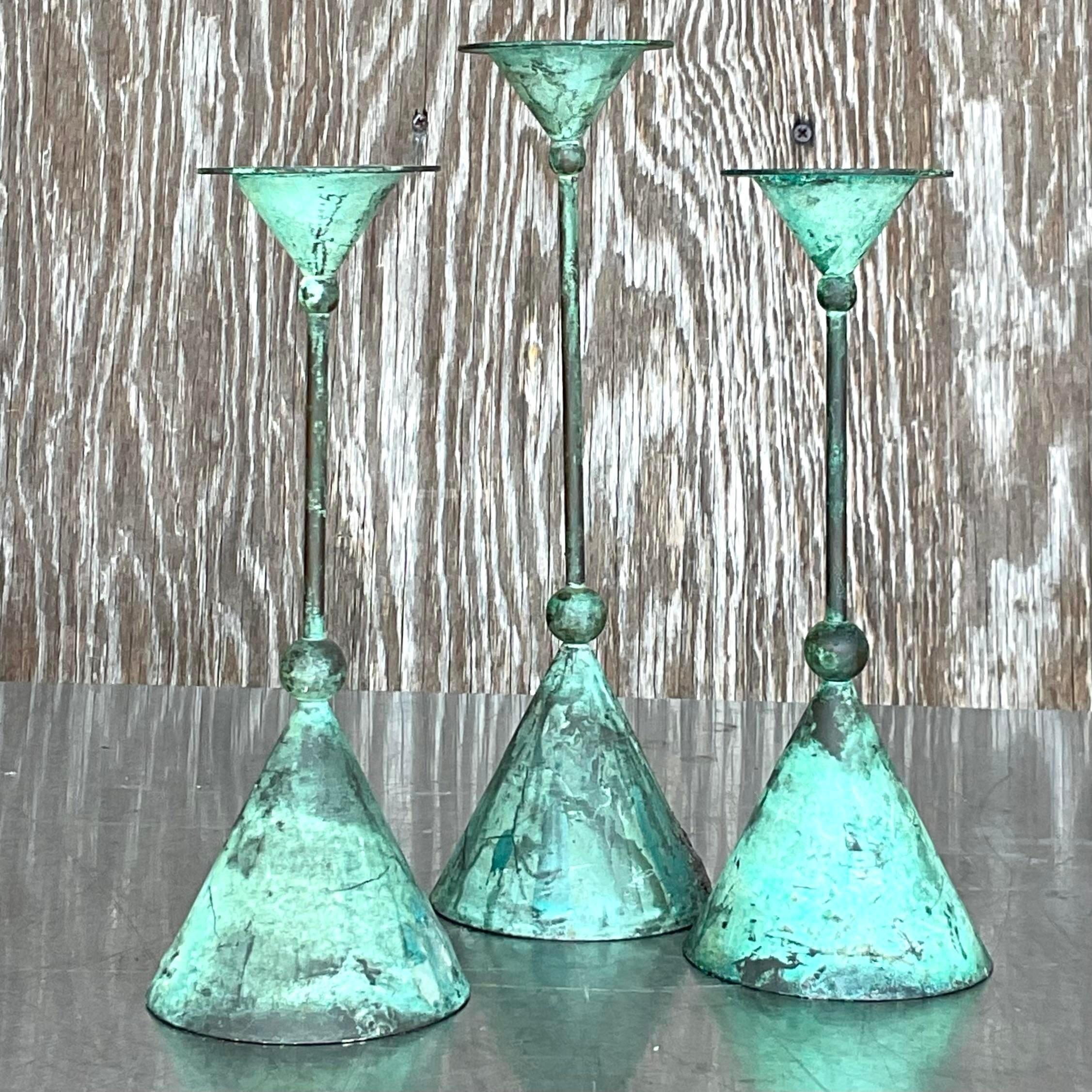 A fantastic set of three vintage Boho bronze candlesticks. A chic Postmodern style in a beautiful verdigris finish from time. Acquired from a Palm Beach estate.

Smaller pair is 9.5h