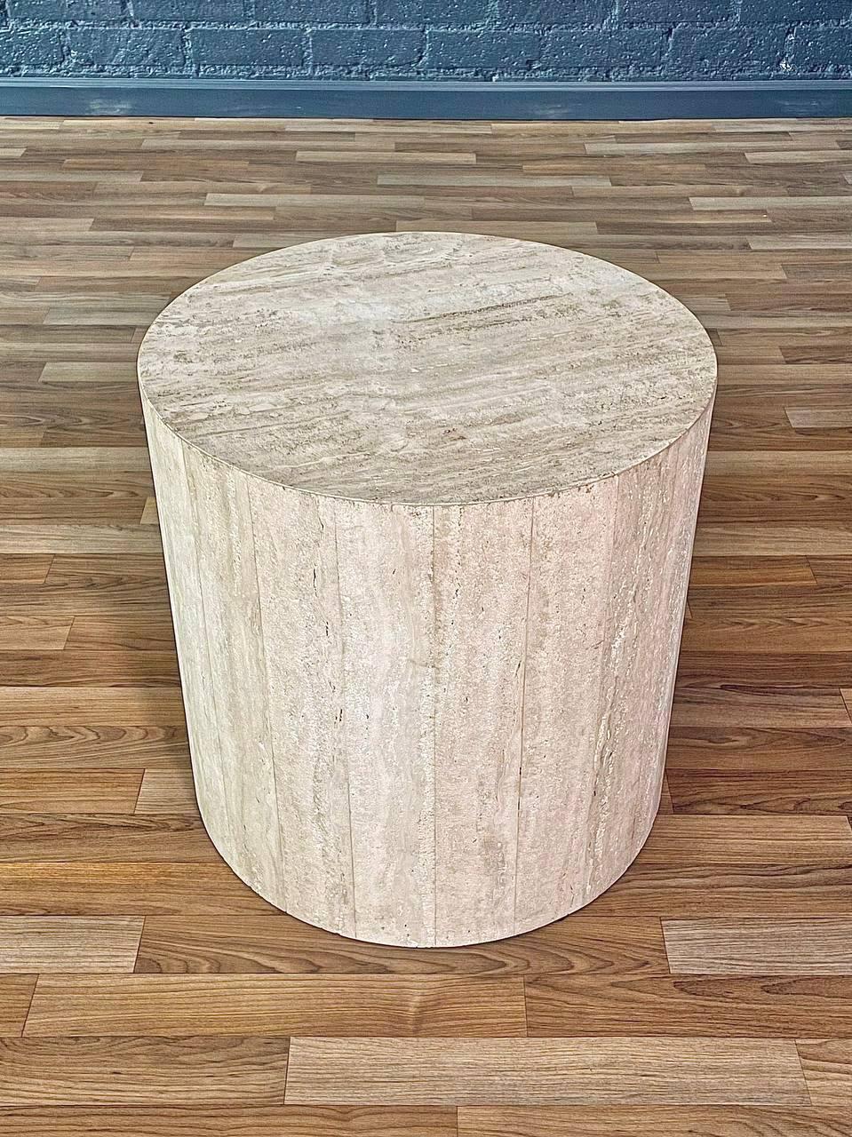 Condition: Original Vintage Condition
Materials: Italian Travertine Stone

This vintage Italian pedestal table is a striking example of Post Modern minimalism, crafted entirely from natural travertine stone. The bold cylindrical form and continuous