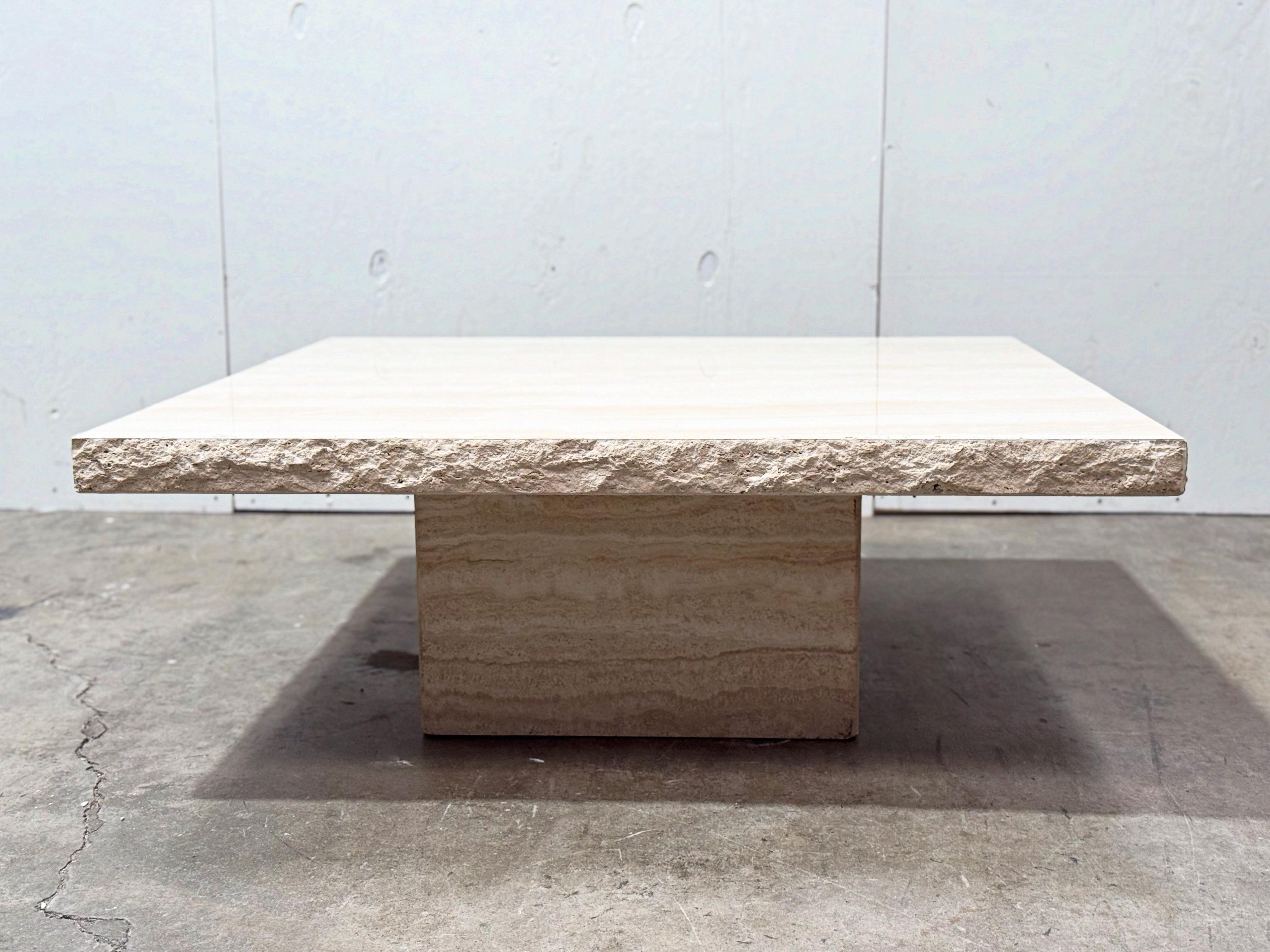 Vintage organic modern Italian travertine square coffee or cocktail table with live edge detail. Made by Stone International, Italy circa 1980s.  Stunning natural movement in the grain pattern with creamy undulating tones.
Excellent condition -