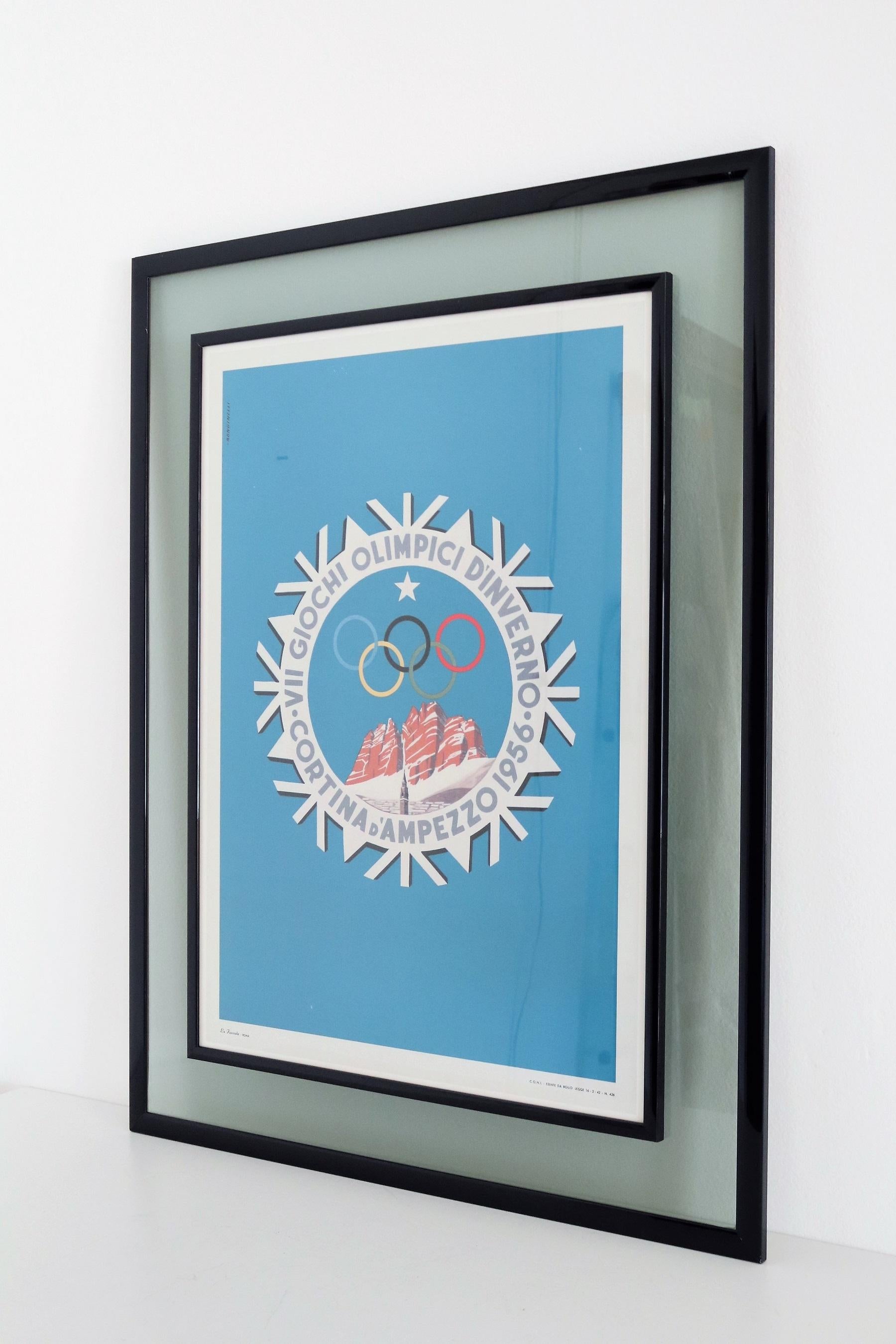 Beautiful wall art of a vintage poster designed by Rondinelli for the winter Olympic Games in Cortina d'Ampezzo, Italy, in 1956.
The poster is in very good condition and comes with its original wood and double glass frame in blue color.
There are