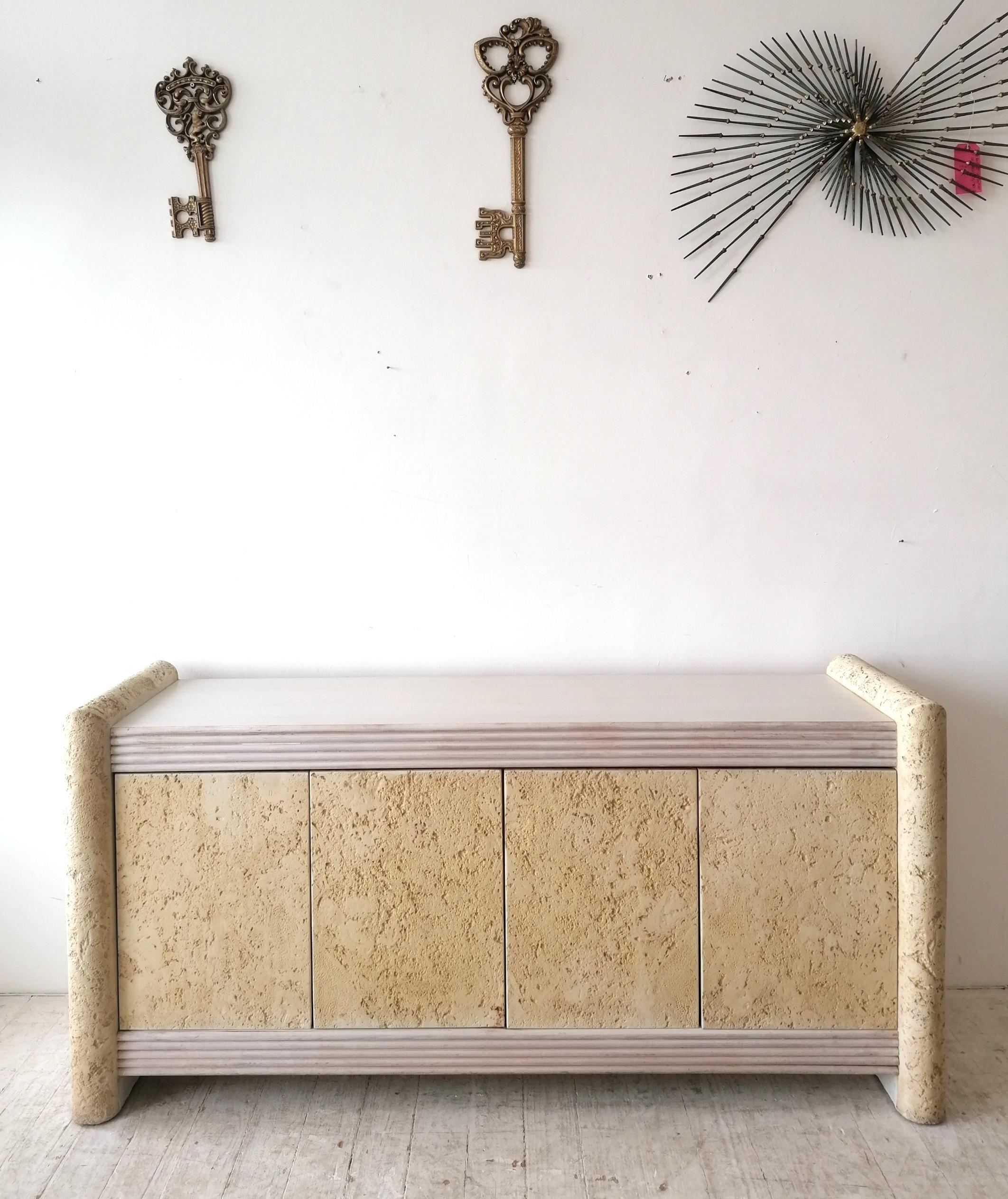 Stylish postmodern American textured concrete & cane sideboard, c1980s.
Top and ends are woodgrain laminate. The textured concrete is a simulation of  'coral stone'- a type of limestone.
Push-Click doors : drawer & storage space at left; adjustable