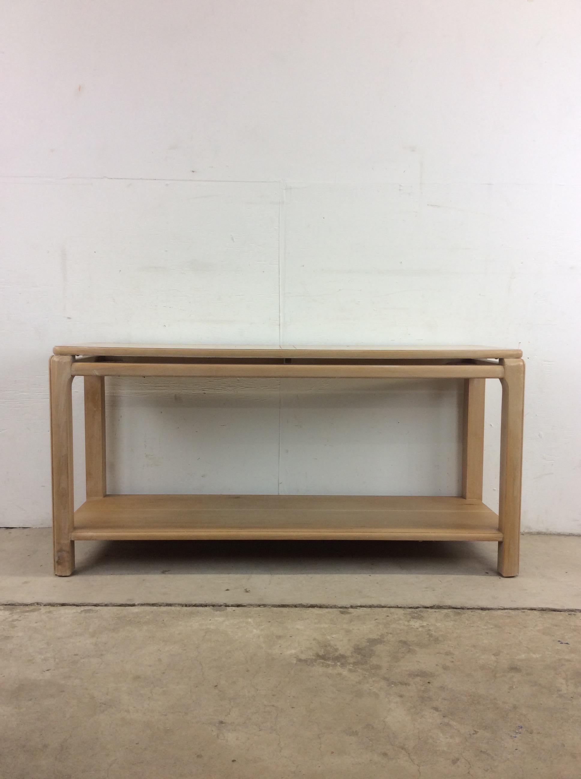 This vintage postmodern console table by Lane Furniture features hardwood construction with a light washed Burlwood finish. Plenty of surface area up top for knick knacks and still more space below on the opened shelving.

Dimensions: 53w 18d