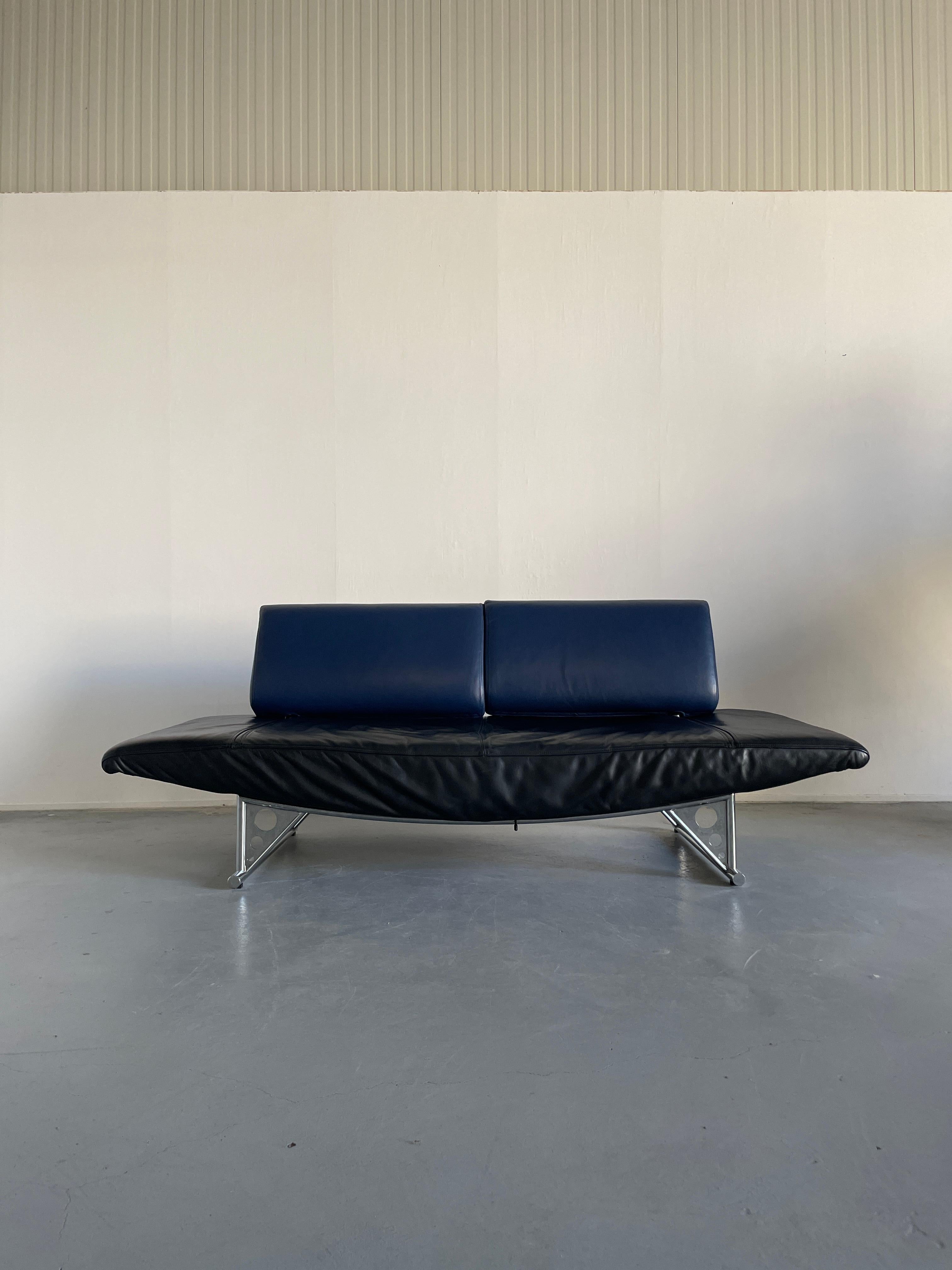 'Cirrus', a postmodern loveseat two-seater sofa designed by Peter Maly and produced by the famous German furniture manufacturer COR.
Black and blue leather edition with the triangle chrome metal base.
The back cushions can be rotated and swiveled,