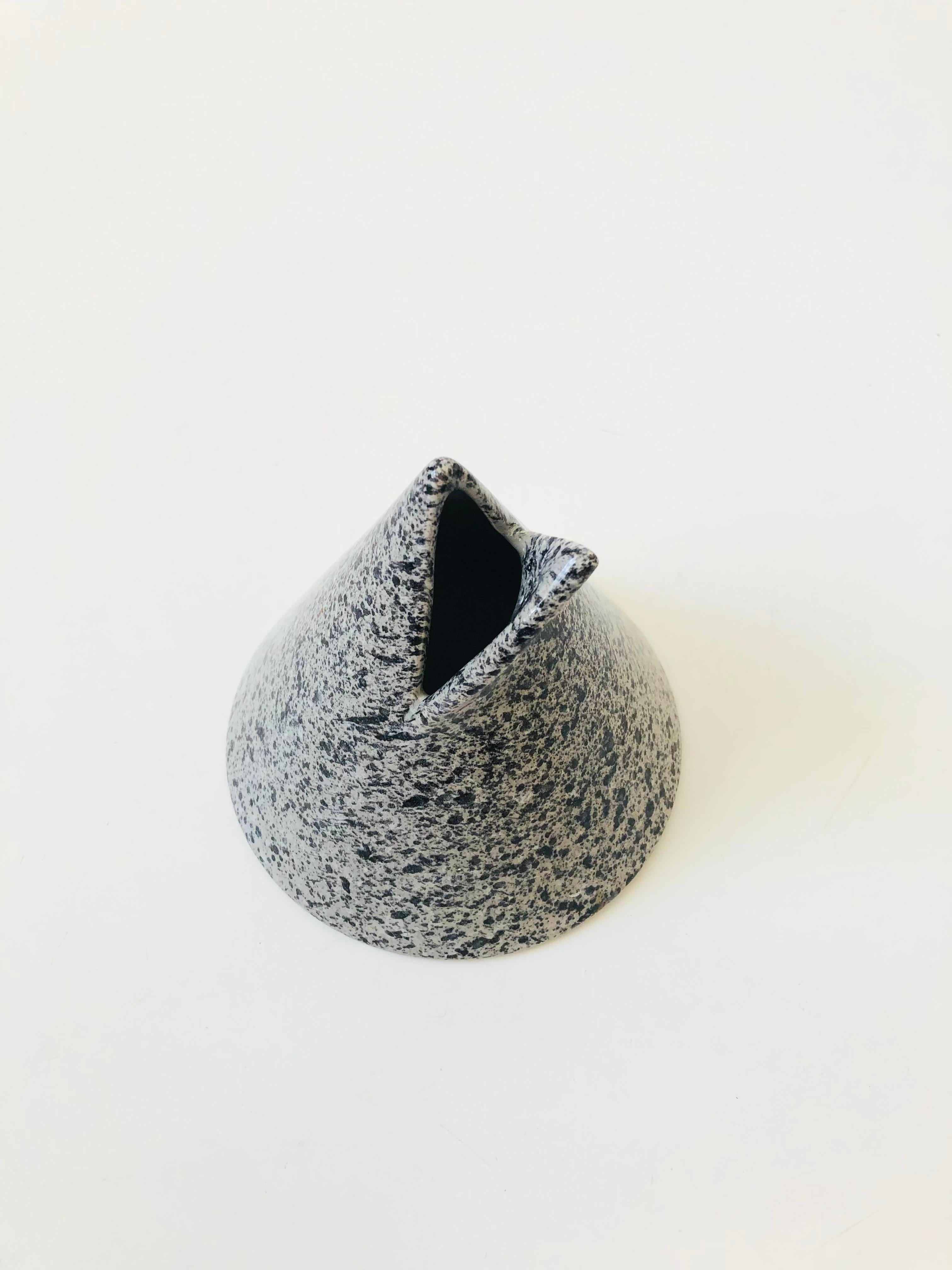 A vintage ceramic bud vase with a great postmodern design. Conical shape with a cut flap in the top that has been pulled back to create the vase opening. Finish in a glossy speckled gray glaze. Designed by Helena Uglow for Mikasa, Japan.

