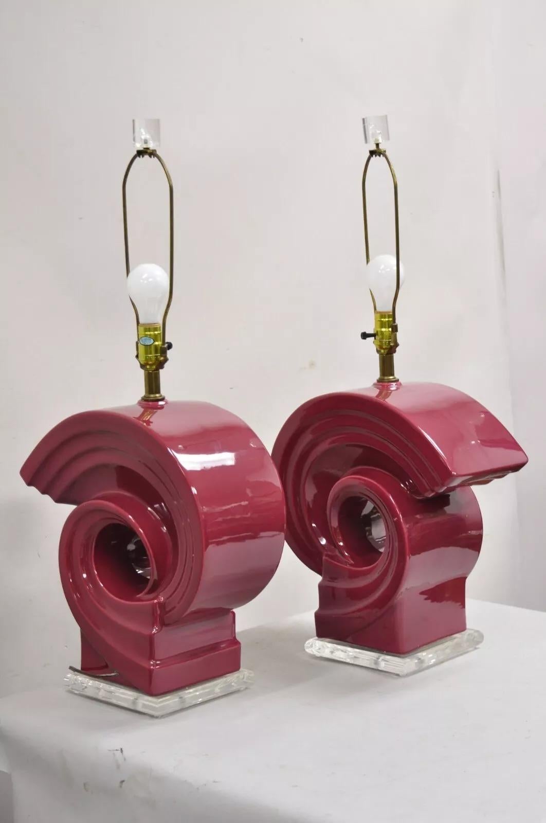 Vintage Postmodern Cranberry Red Sculptural Snail Scroll Ceramic Table Lamps on Lucite Bases - a Pair. Circa Late 20th Century. Measurements: 32