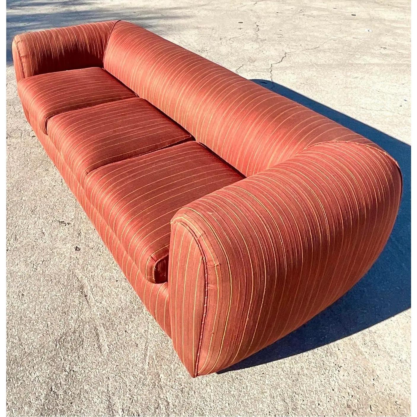 A fantastic vintage Postmodern sofa. A beautiful overstuffed roll arm and hidden seam detail. Perfect as is or recover in a chic mohair. The shape is just amazing. Matching lounge chair also available. Acquired from a Palm Beach estate.