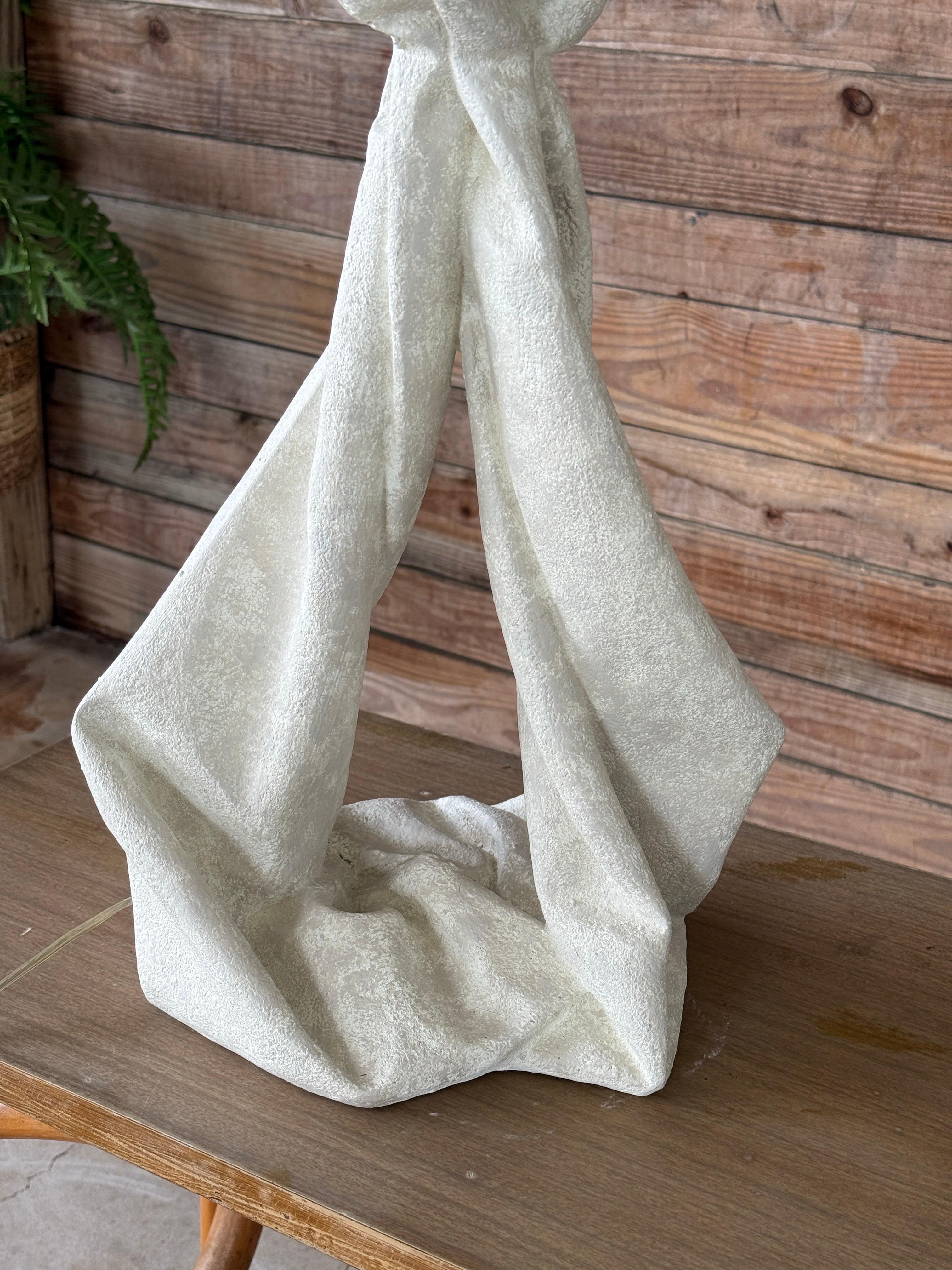 Sculptural and striking, this vintage postmodern plaster table lamp evokes the iconic draped style associated with John Dickinson. The base mimics flowing fabric tied in a loose knot, crafted in heavily textured white plaster for a bold, textural