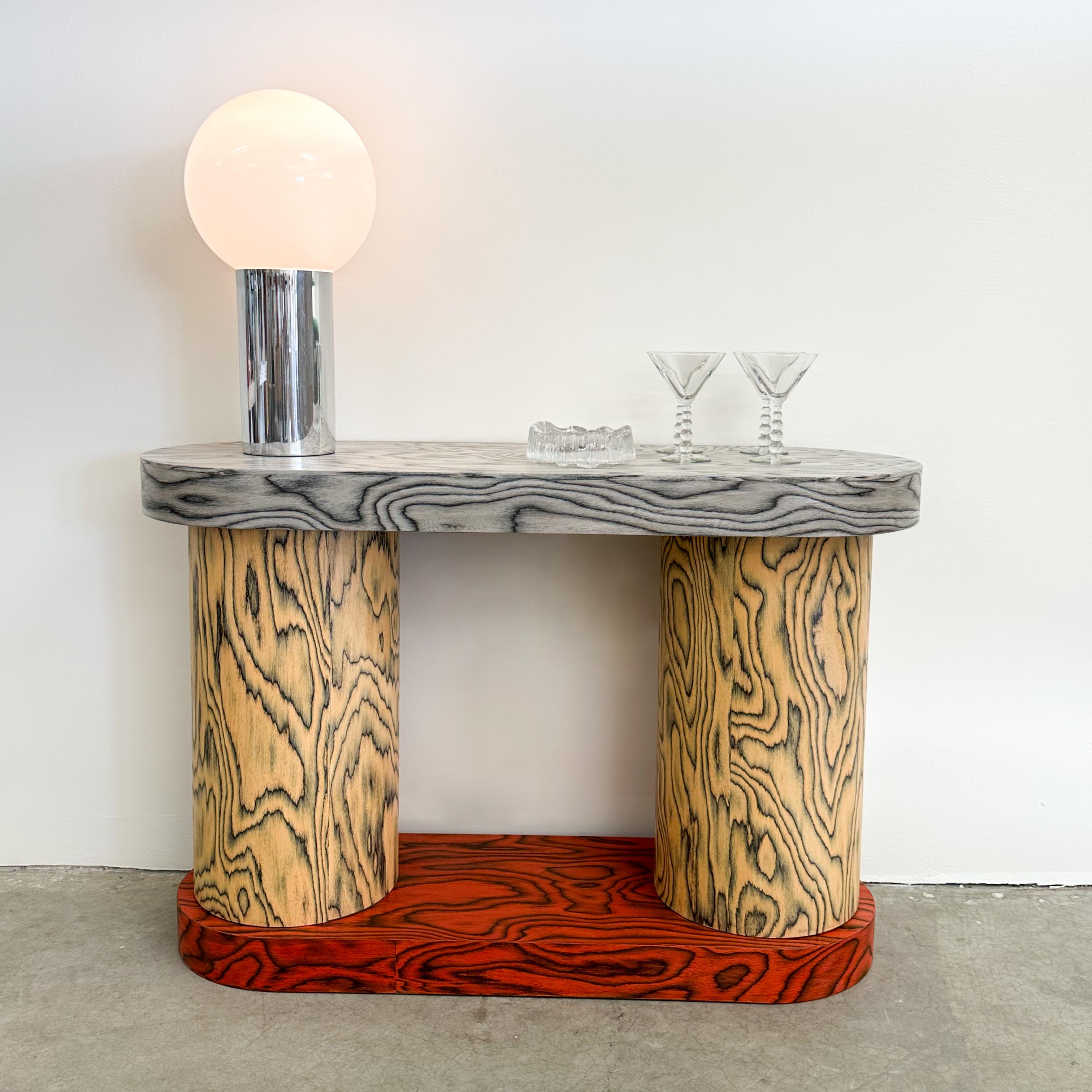 Vintage Postmodern Dry Bar/Console/DJ Table.

Showcasing an exclusive Ettore Sottsass Veneer design. This multifunctional piece can serve as a dry bar, console, or DJ table. Meticulously re-veneered with the original Ettore Sottsass pattern from
