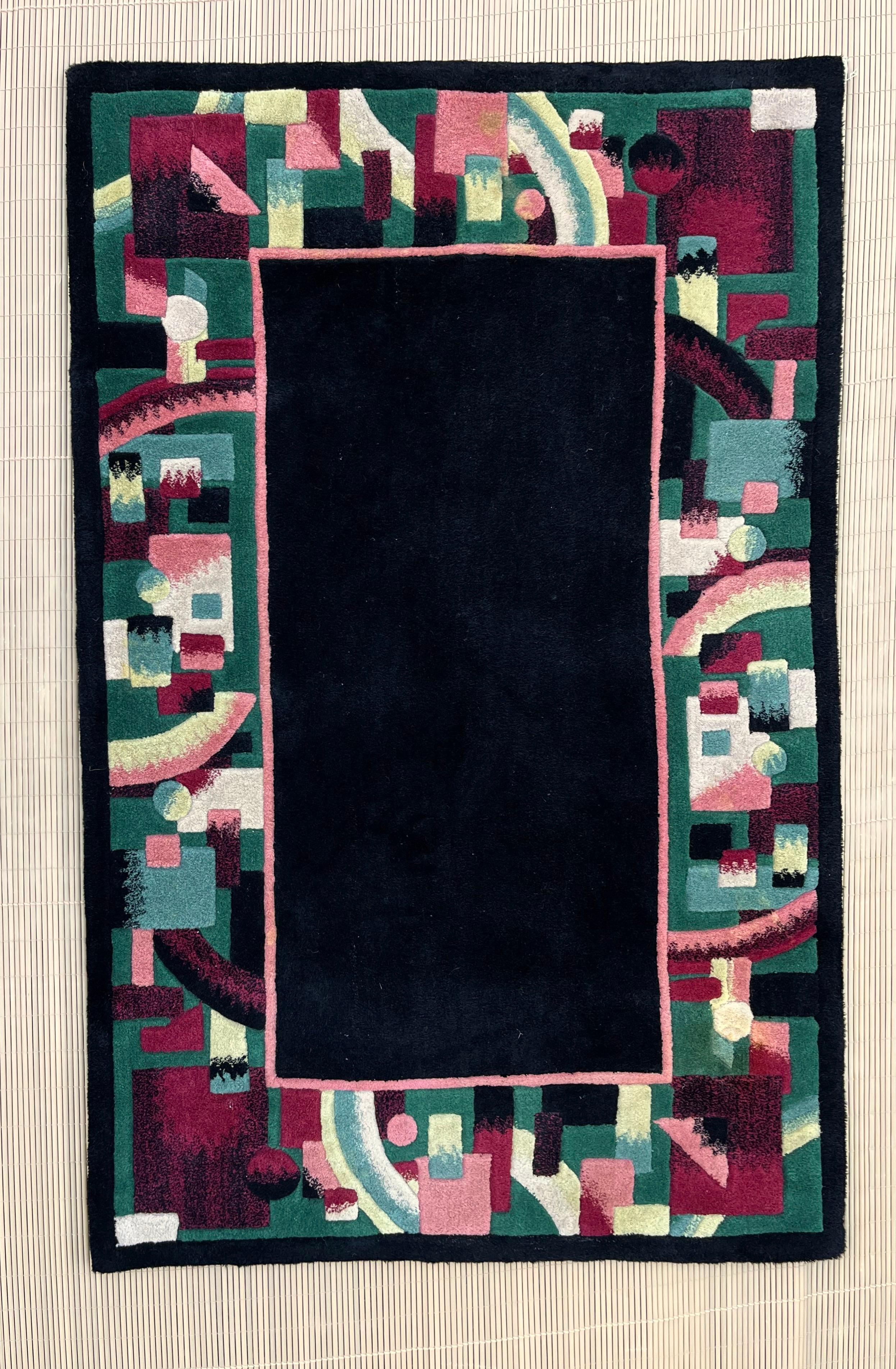 Vintage Postmodern Geometric Area Rug. circa 1980s
Features an abstract design on tufted wool in dark tones of greens, magenta, and cream around a black center.
In excellent original condition with minor marks from previous use. Please See close
