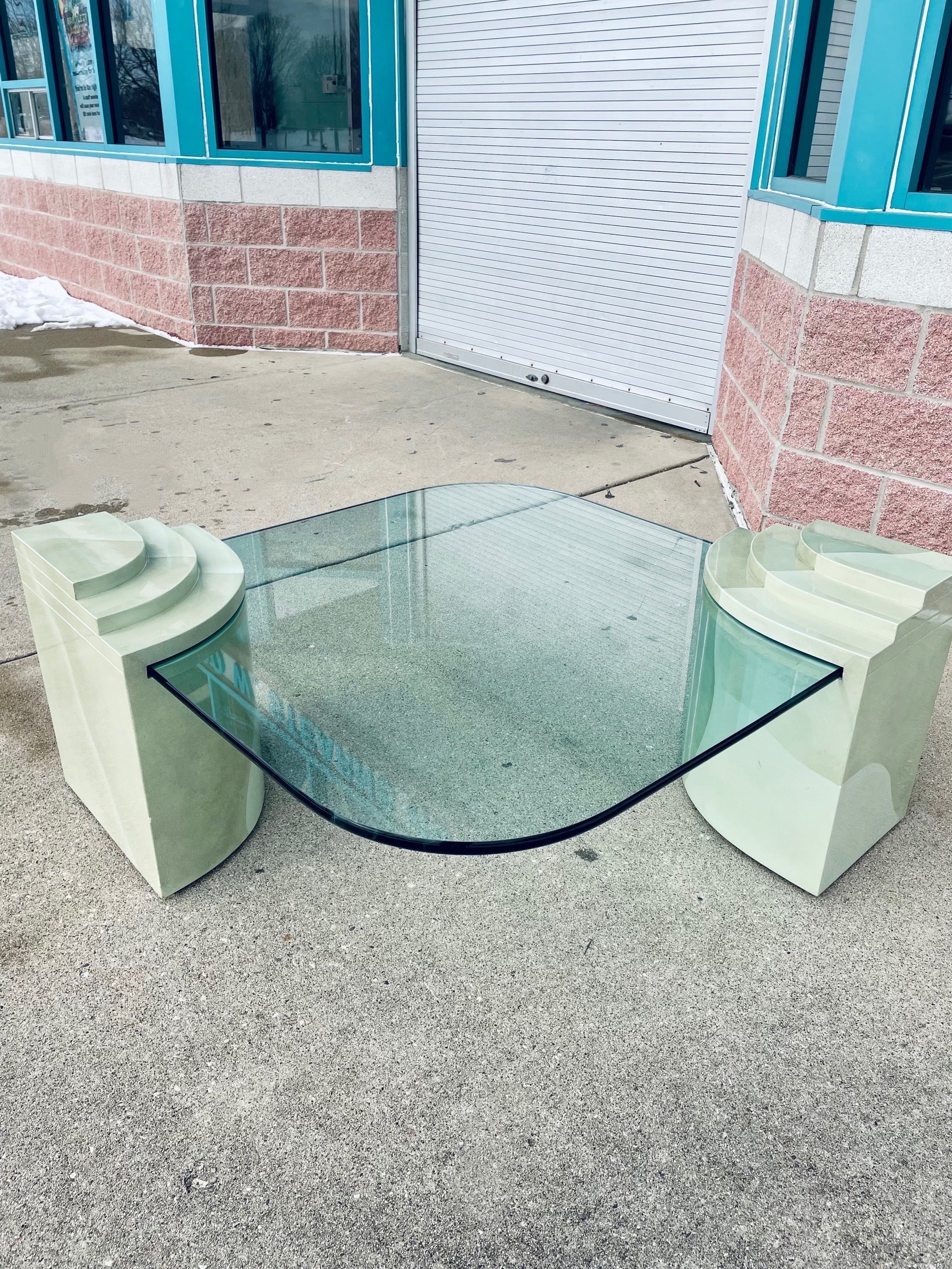 Absolutely striking Postmodern glass tiered base Ombre coffee table. This glass vintage beauty is rare with its multi green colored bases. This rare find is sure to make a statement in any unique interior space. The layout of the table can be placed