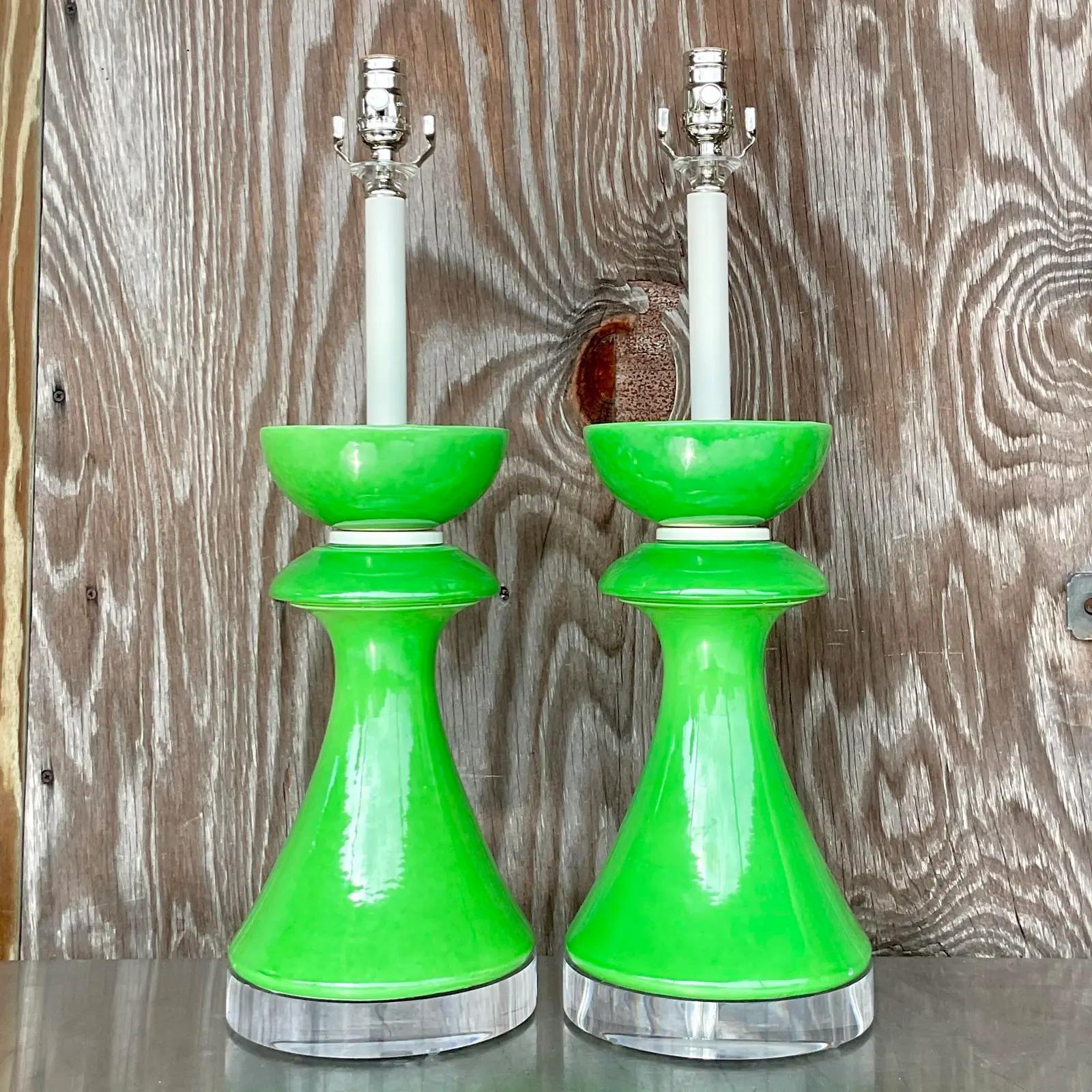 A fabulous vintage Postmodern pair of table lamps. A brilliant Kelly green in a glazed ceramic finish. Fully restored with all new wiring, hardware and lucite plinths. Acquired rom a Palm Beach estate.