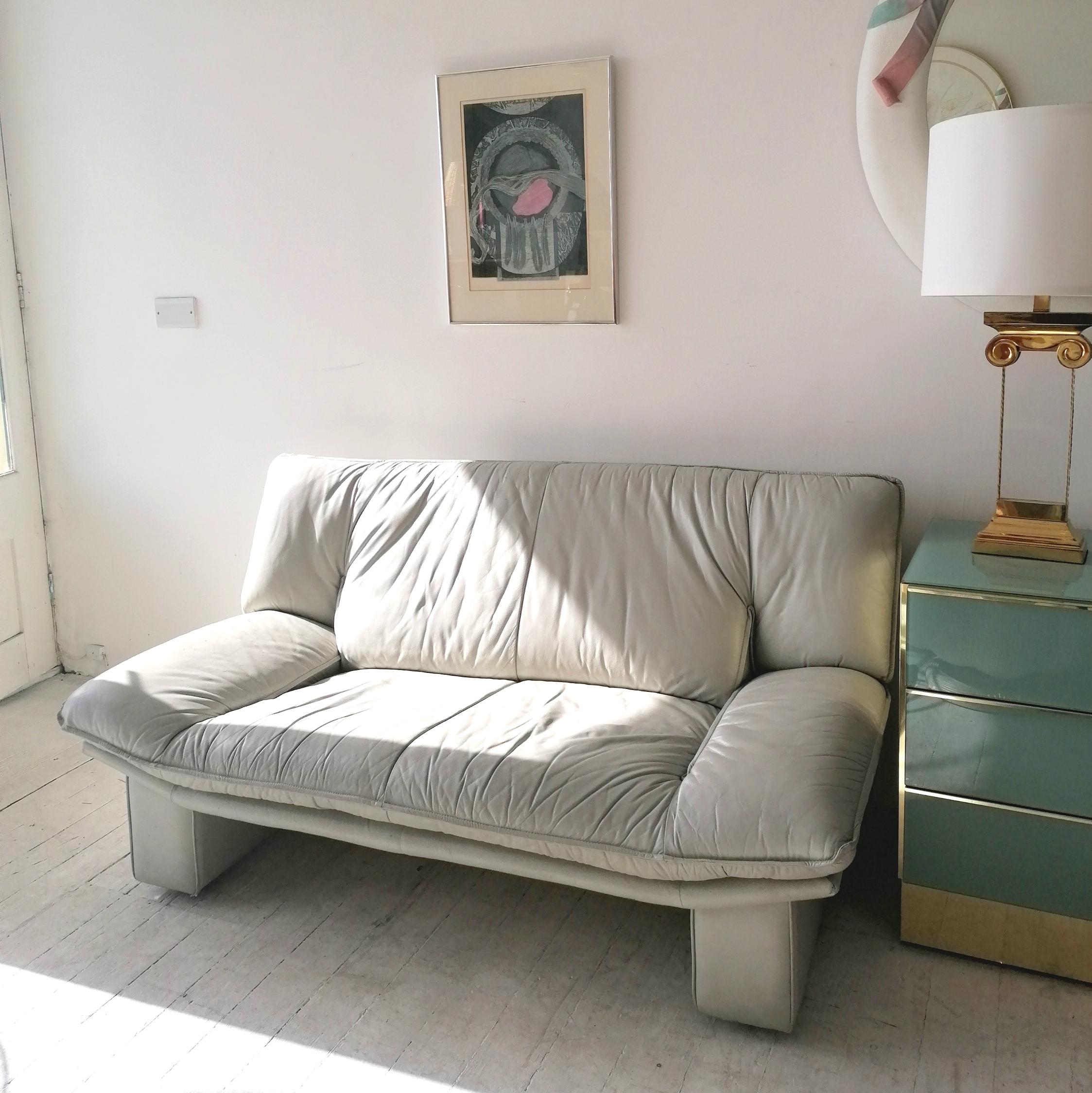 This stylish vintage postmodern pale grey leather sofa is by Nicoletti Salotti, Italy, 1980s. Generally in good vintage condition- some age-related scuffs and scratches, and a slightly ragged corner at the front left (see photos). Lovely soft