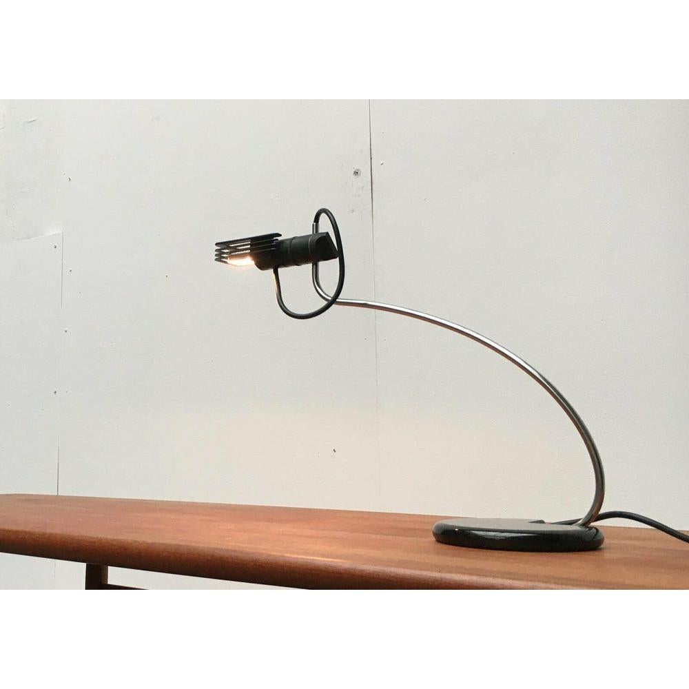 Rare table lamp from the Italian manufacturer Oluce based on a design by Bruno Gecchelin from the 70s.

An elegant design that was ahead of its time in its design language at the beginning of the 70s. There is a small lamp head at the top of the