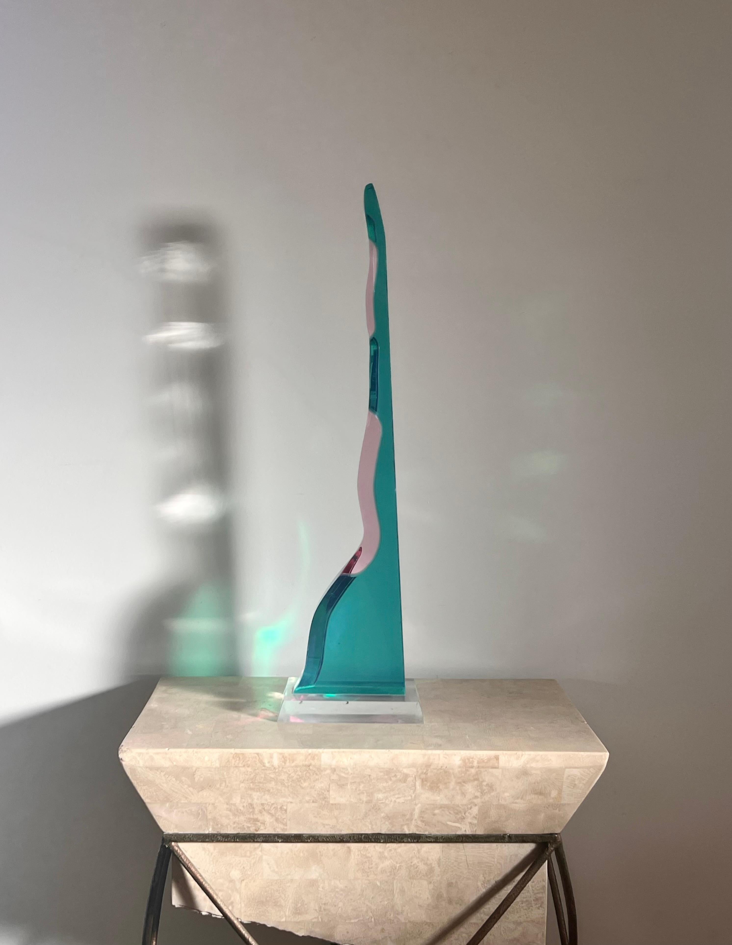A tall abstract sculpture in lucite or acrylic, circa late 20th century. Tones of swimming pool blue, fuchsia, and ice pink. Slight scuffs along base as well as a small chip to top of sculpture - otherwise good condition. Refer to pics for detail