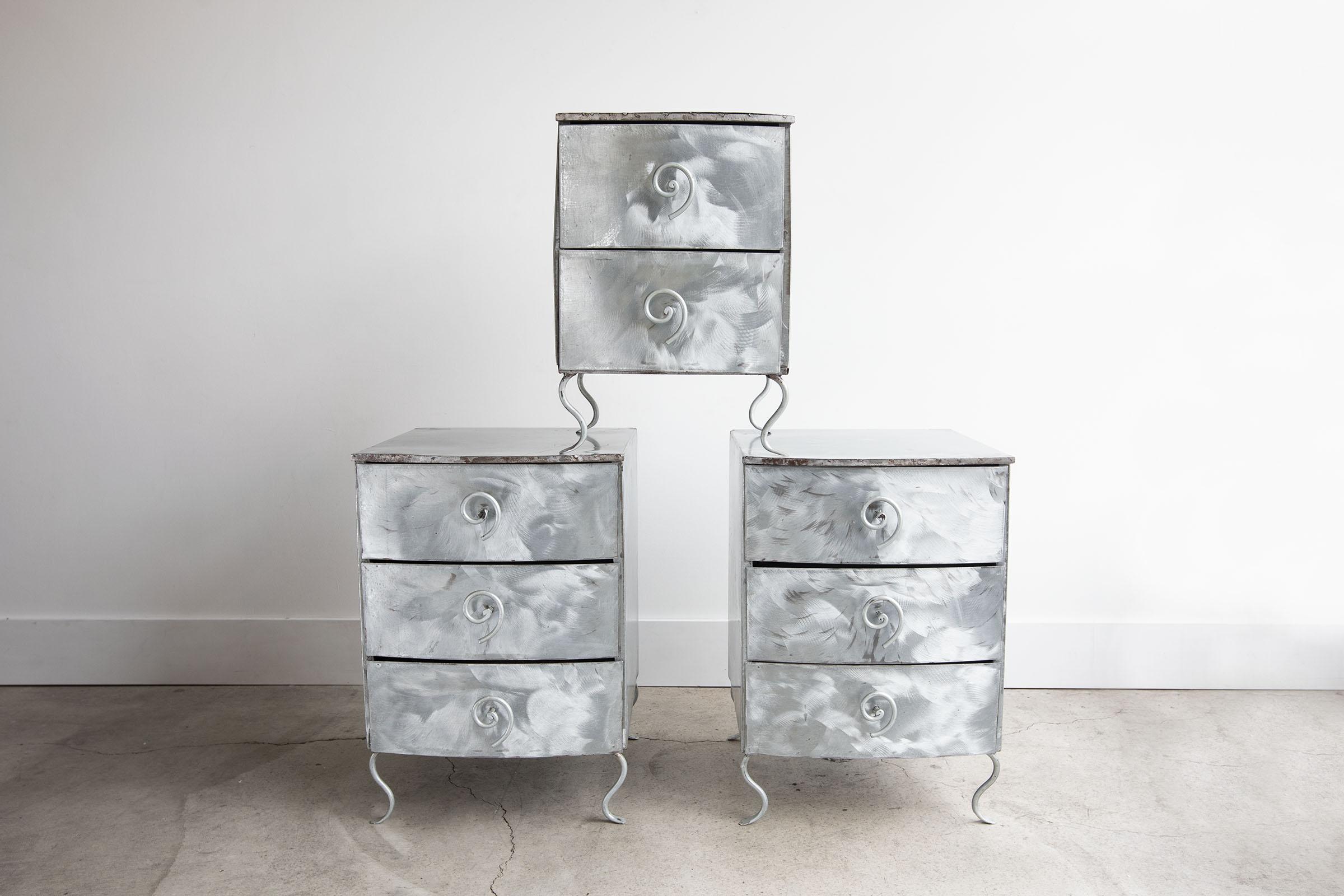A stunning example of 1980s Postmodern Memphis design. Three handmade blushed aluminum nightstands or end-tables with swirl drawer pulls. The maker of these is unknown but they're handmade and are very special. Would be amazing in any setting. Great