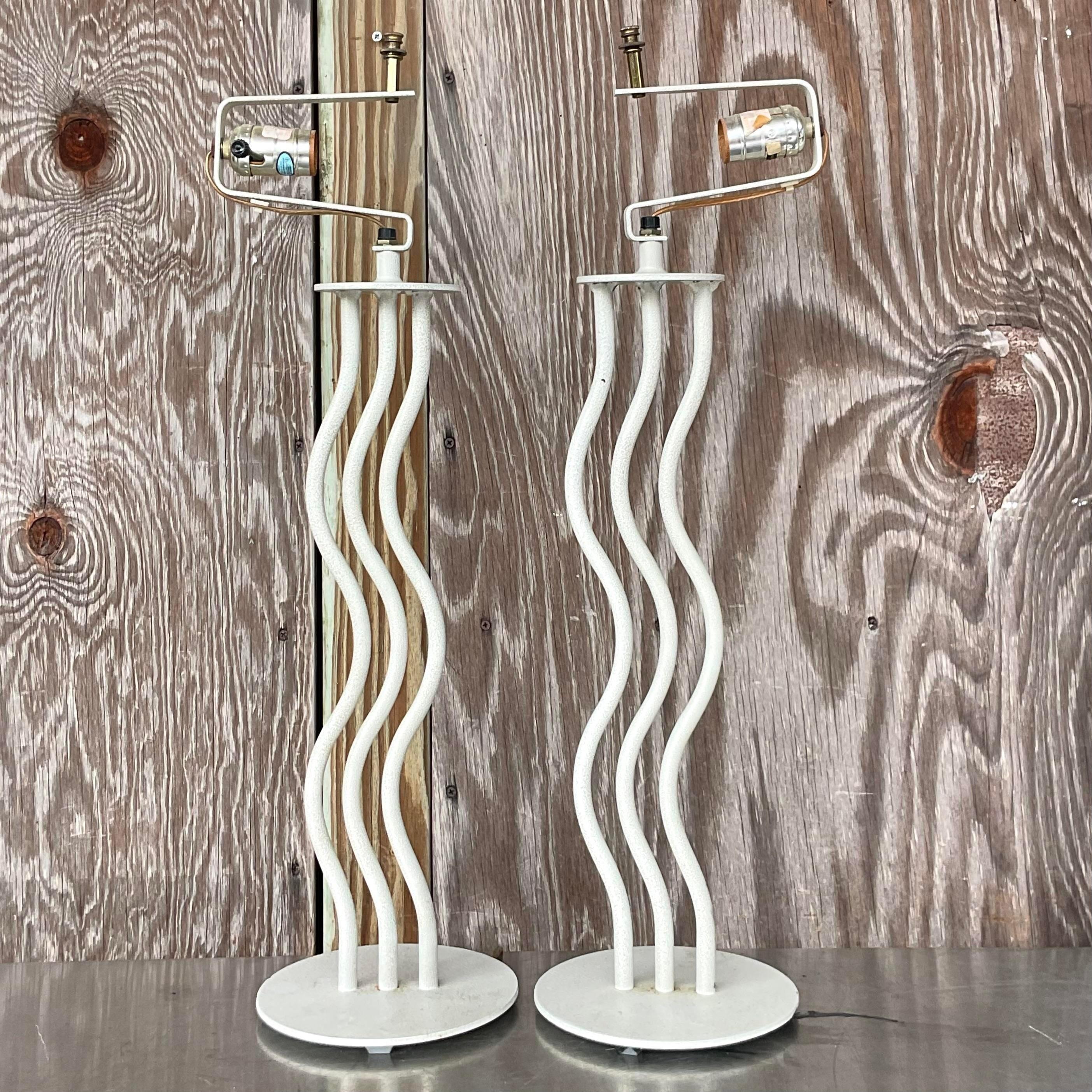 A fabulous pair of vintage Postmodern table lamps. The iconic wave design in a painted metal. Acquired from a Palm Beach estate.