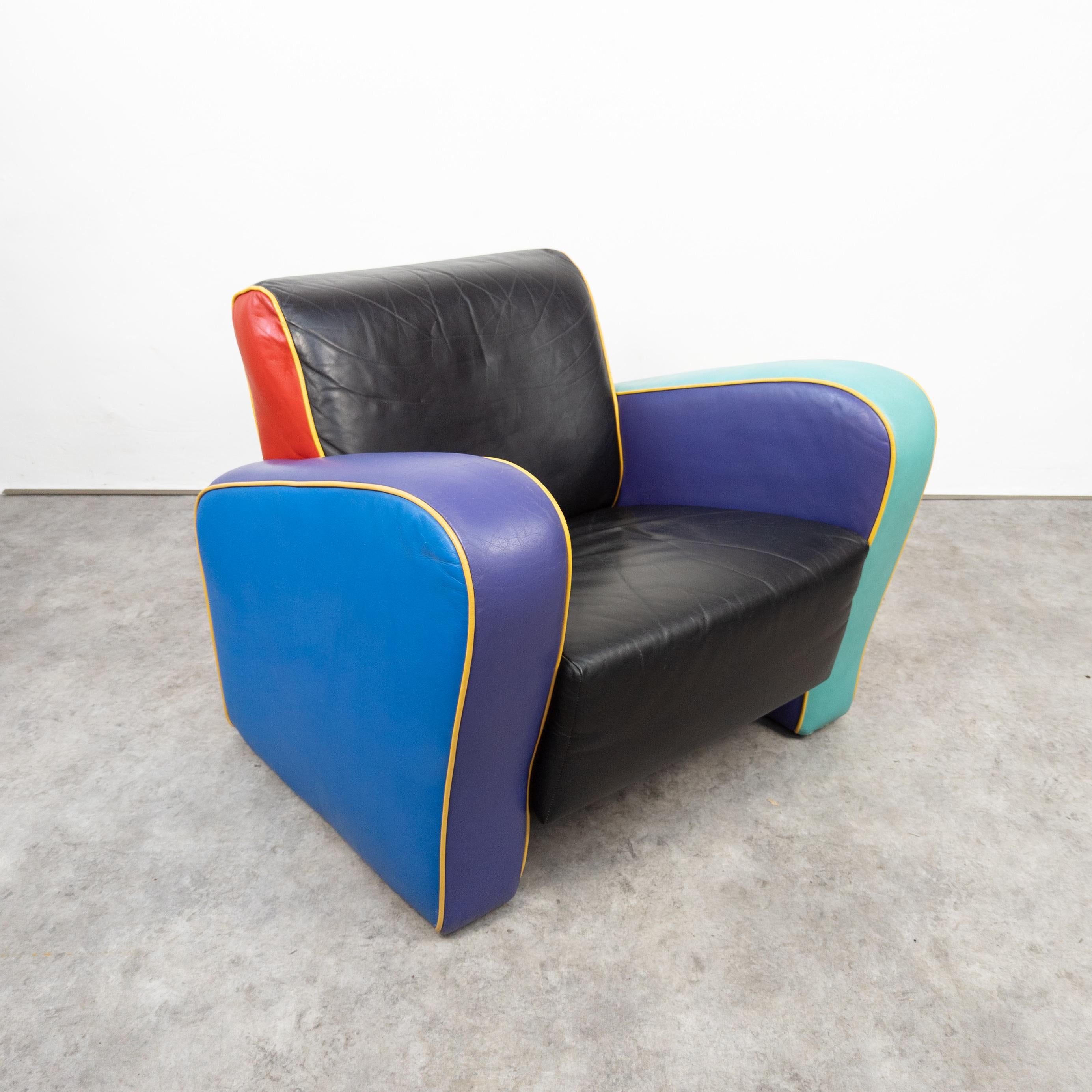 1980s armchair inspired by Harry Siegel. Upholstered in multiple colors vinyl. In good vintage condition with some traces of wear and age, few scratches on the vinyl. Structurally sound. Dimensions: height 70 cm, width 85 cm, depth 80 cm, seat