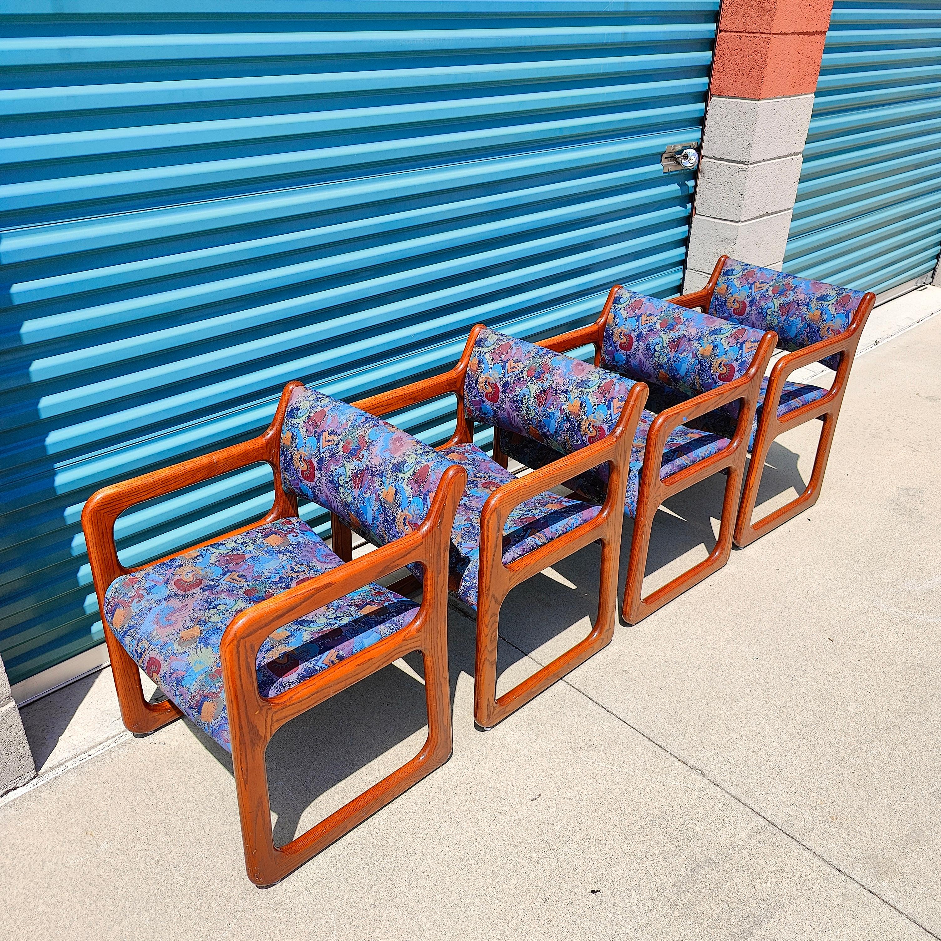 All very sturdy, in original condition with stylish fabric. They date back to the 90s. Oak frames with some wear throughout, however, no breaks. Real stunners in person. Each chair measures approximately 22W x 19D x 29.5H with an arm height of