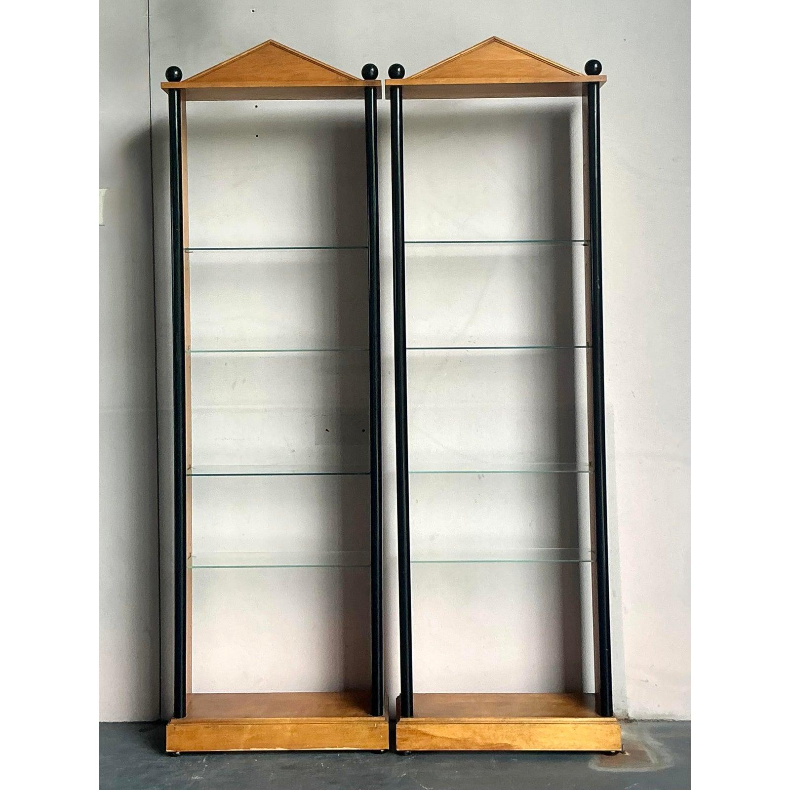 Presenting a striking pair of vintage Postmodern etageres, each featuring a distinctive pediment top that evokes classical architectural grandeur while embracing a modern aesthetic. These pieces are masterfully crafted with rich, warm wood tones