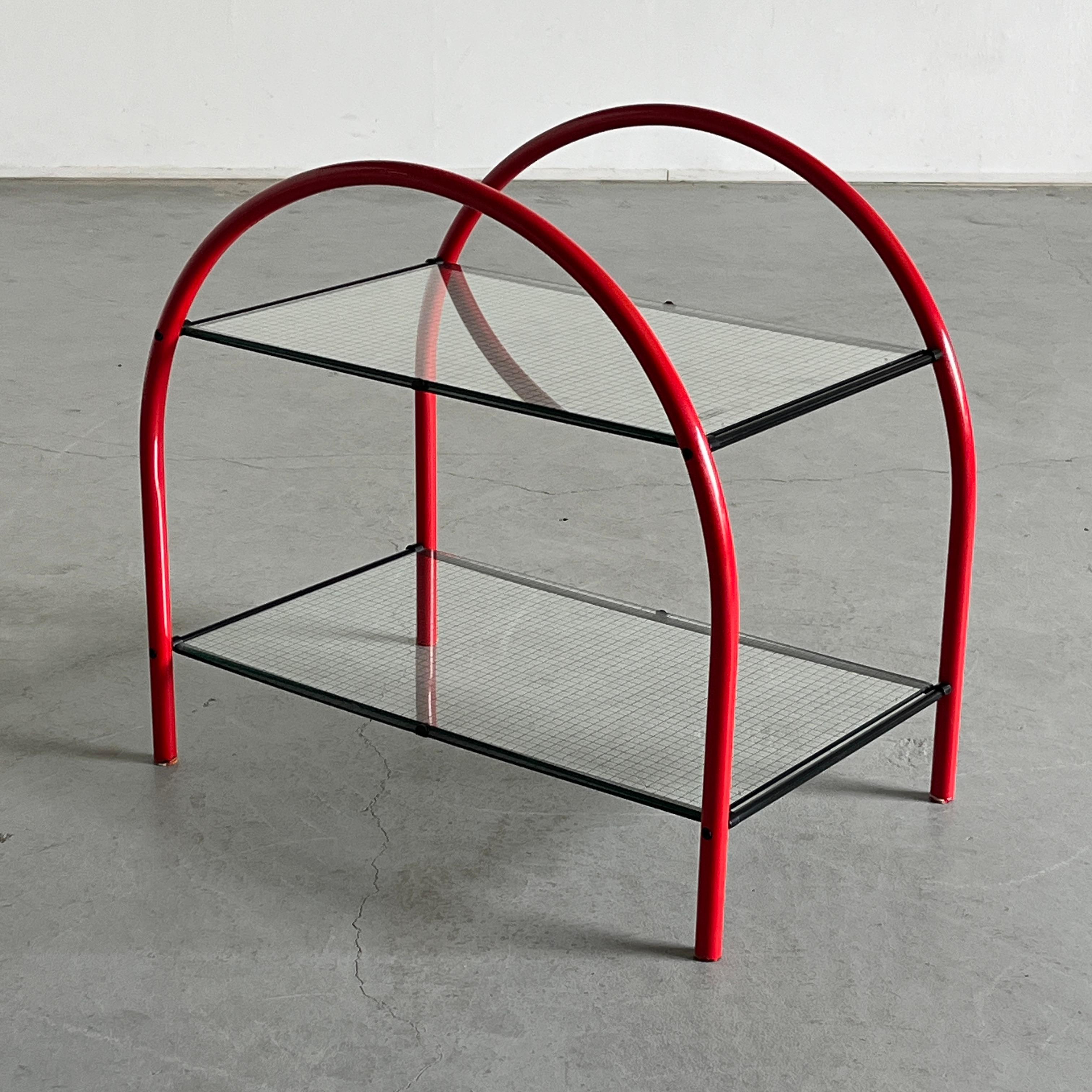 Playful and geometrical vintage postmodern ‘Pomo’ side table designed by Anna Anselmi for Padua-based Italian manufacturer Bieffeplast in the early 1980s. It is composed of simple shapes; two curved red metal semi-circles which hold in place black