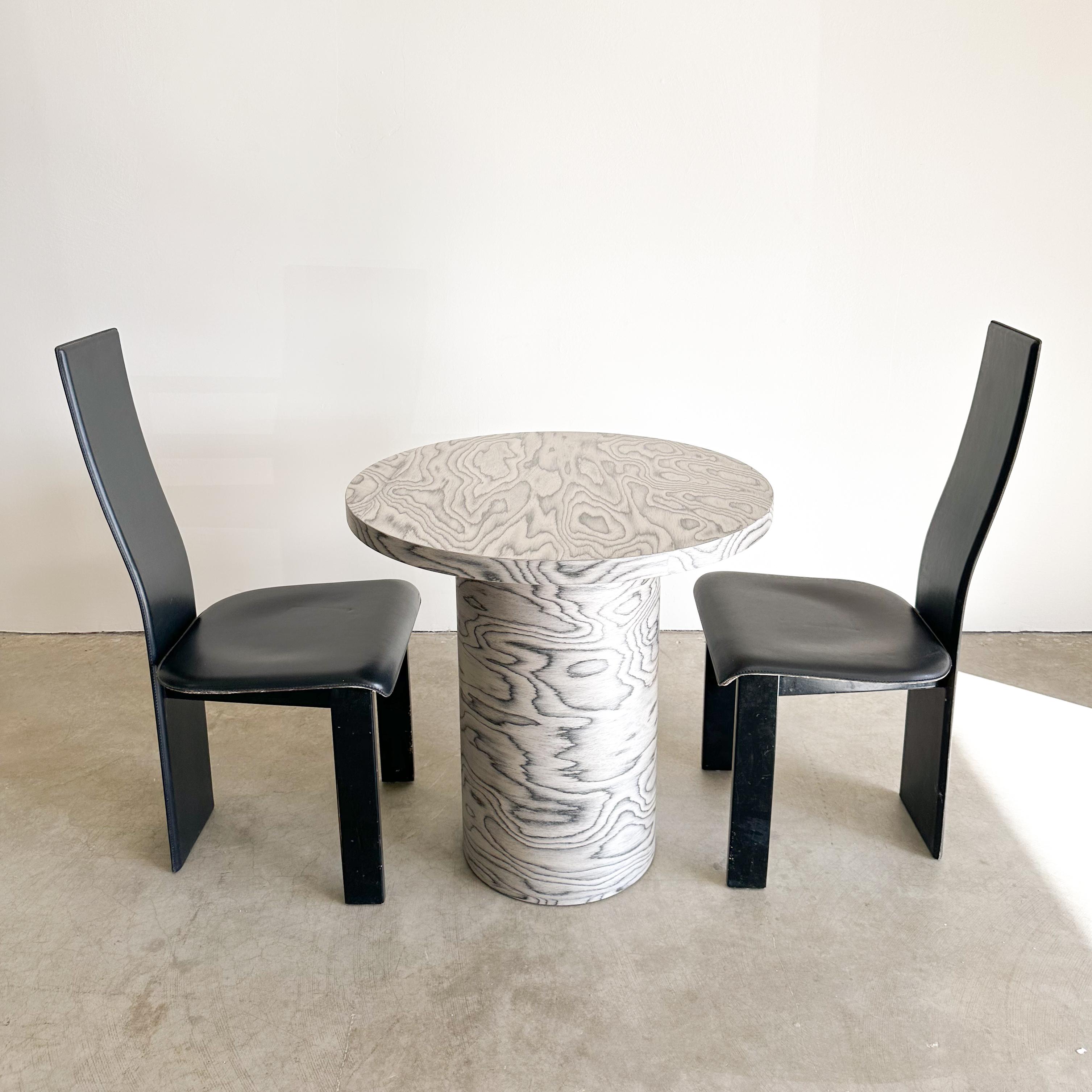 Vintage Round Dining/Kitchenette Table featuring Ettore Sottsass Veneer.

This vintage table features re-veneering with the original ALPI veneer, designed by Ettore Sottsass in 1985 an iconic figure in the Memphis design movement. Its distinctive