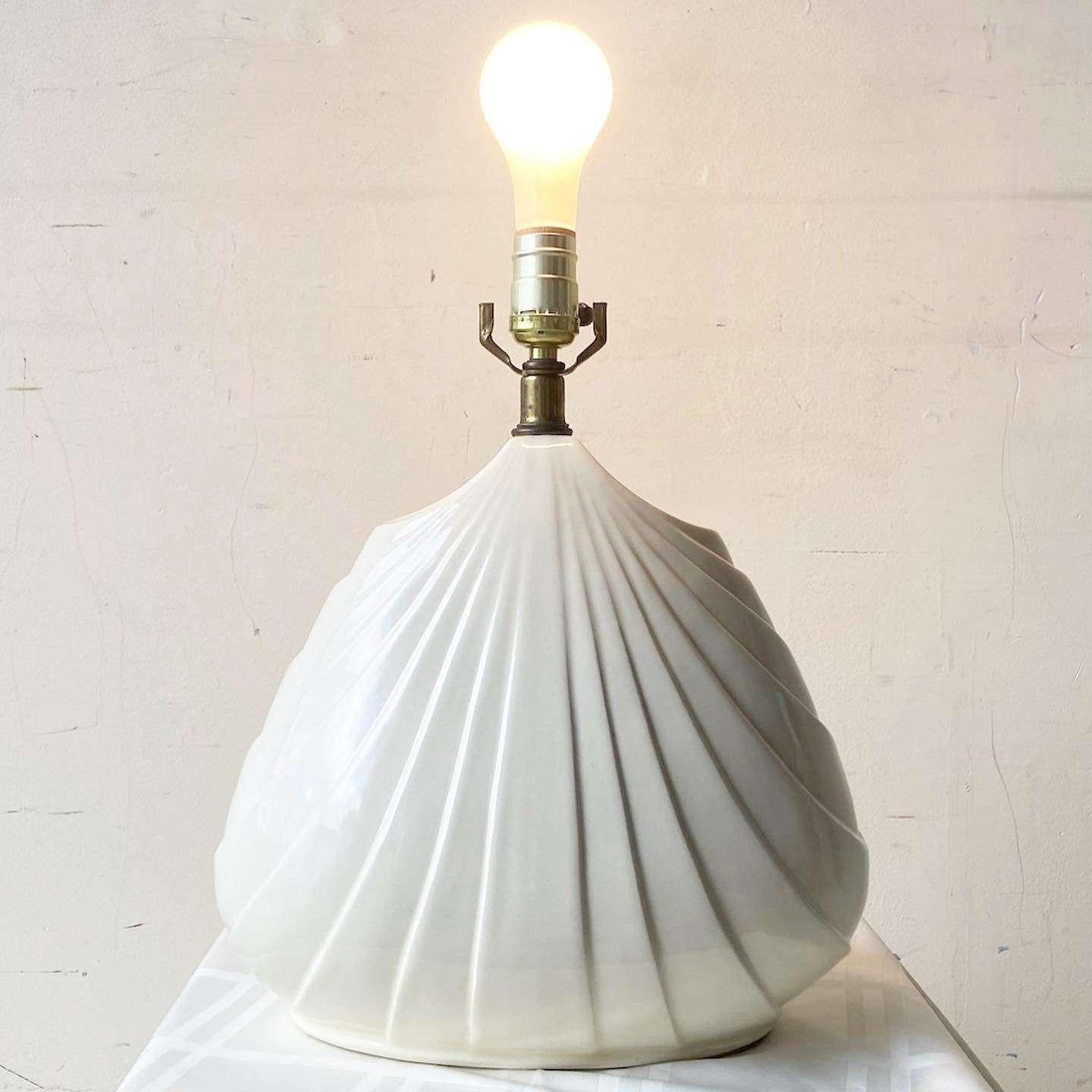 Amazing vintage postmodern sculpted ceramic table lamp. Features a fantastic body with a glossy beige finish.
