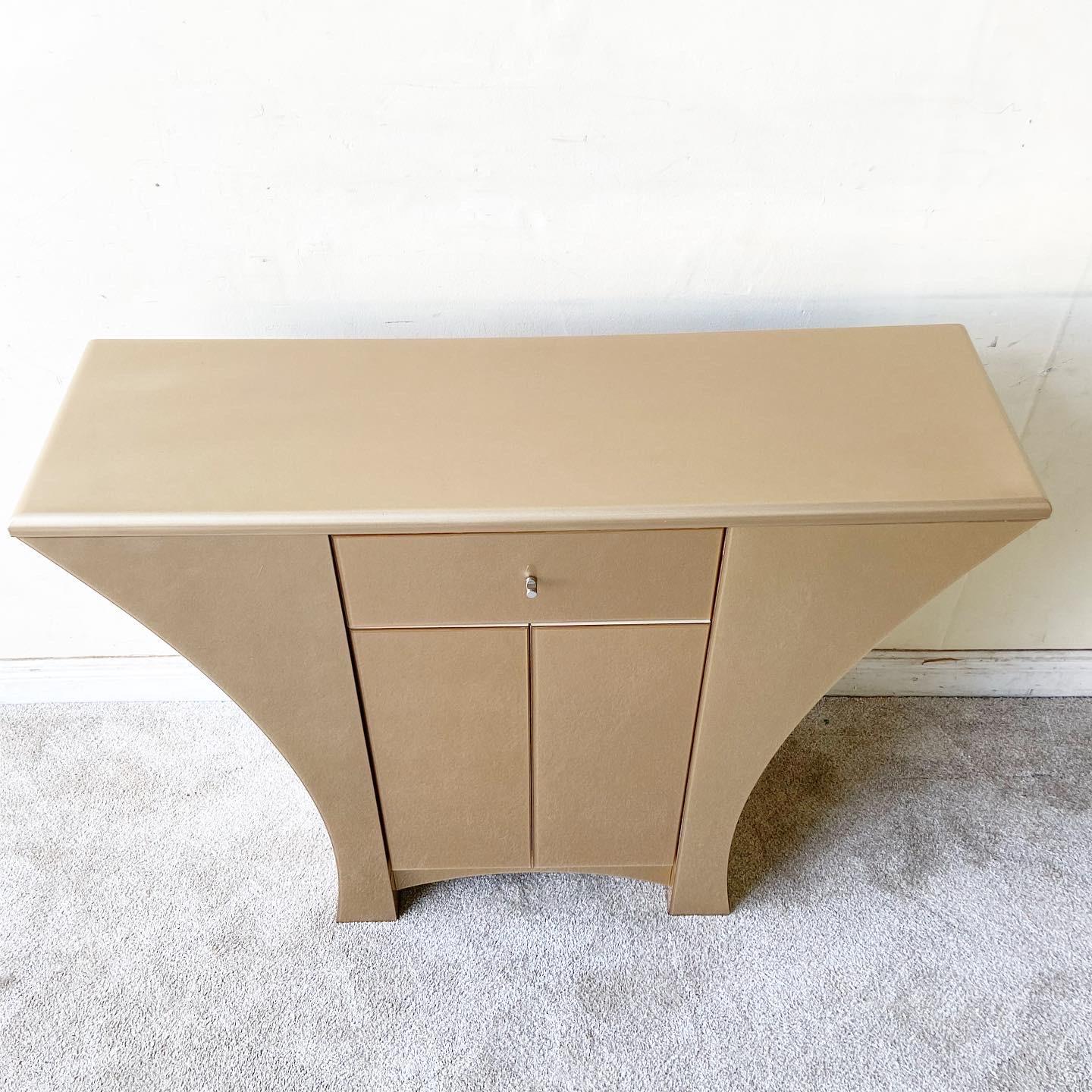 Exceptional art deco/post modern sideboard/credenza. Features a very interesting acrylic over gold frame. The top is lacquered gold and there is one drawer with a cabinet space underneath.