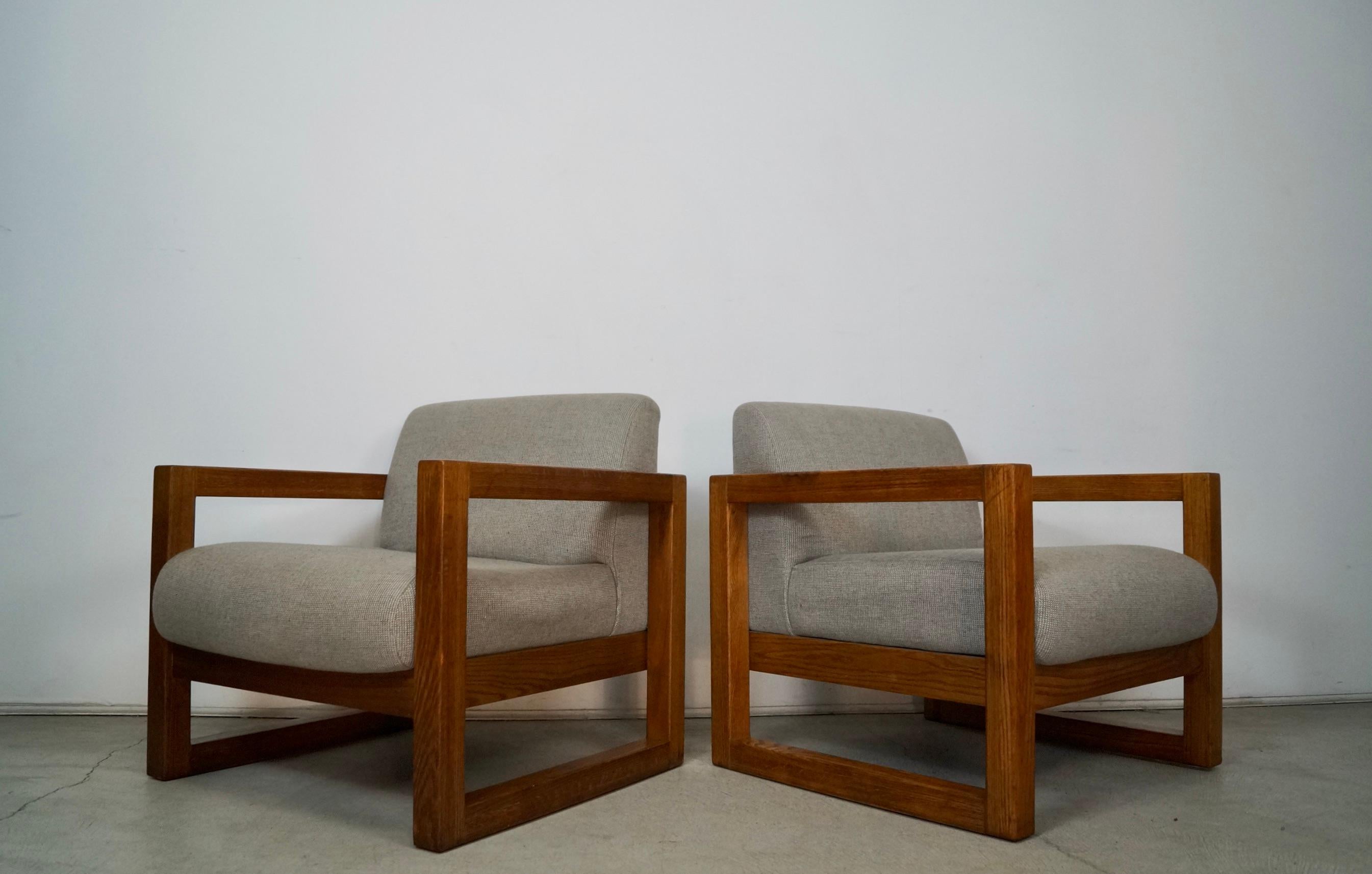 Pair of vintage Mid century Modern lounge chairs for sale. They were manufactured here in the US, and were made by High Point Furniture Industries. They have a solid oak frame in a cube shape, and have the original finish in great vintage condition.