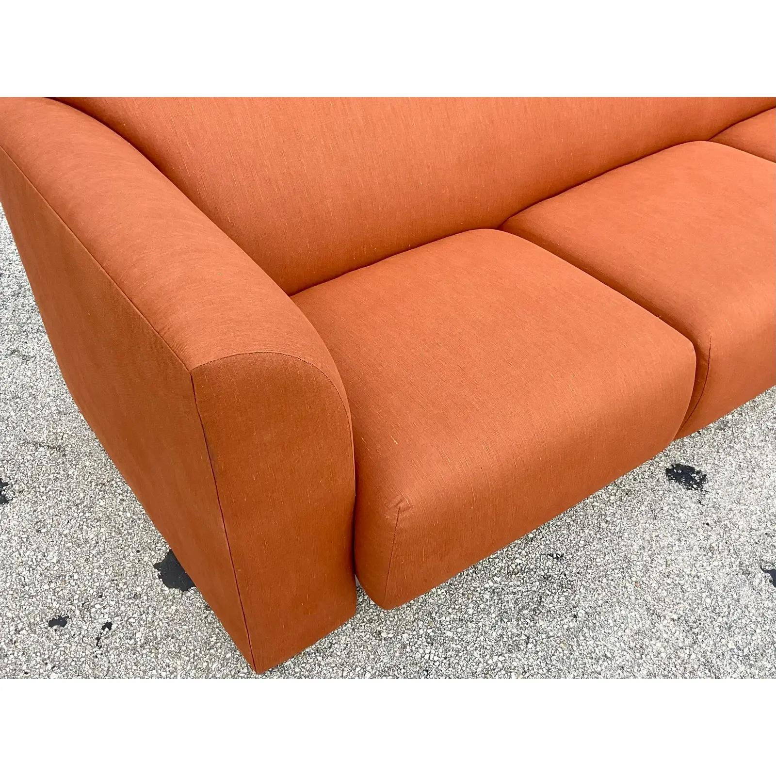 Custom El Morocco Sofa designed by Stanley Jay Friedman in 1985. Newly reupholstered in a cinnamon slub linen. Amazing wave back design with a polished steel kick plate. Unmarked. Acquired from a Palm Beach estate. 