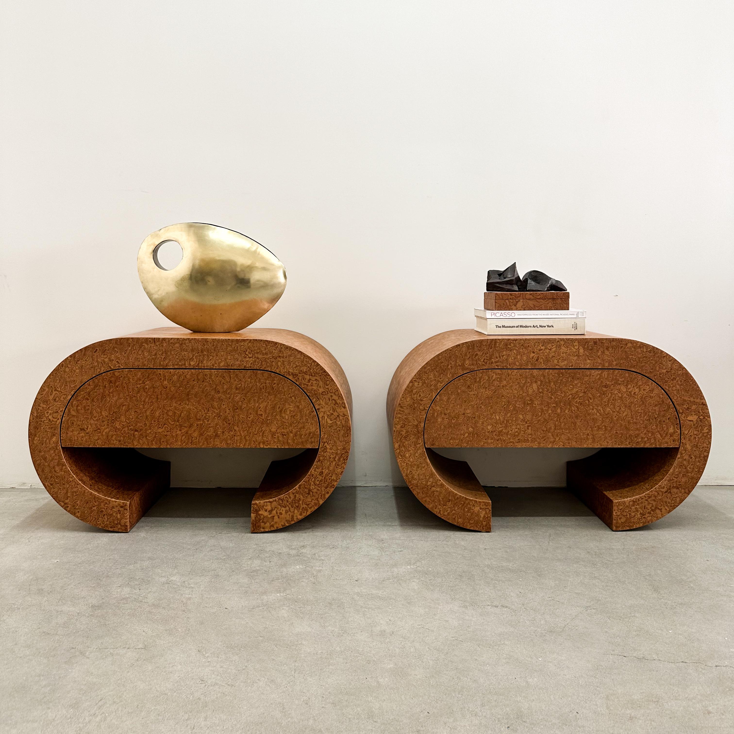 This exquisite pair of vintage postmodern waterfall nightstands or end tables is expertly crafted from Sapele Pommele wood, showcasing its rich, highly figured grain. Their sleek, curved waterfall design makes them a standout addition to any modern,