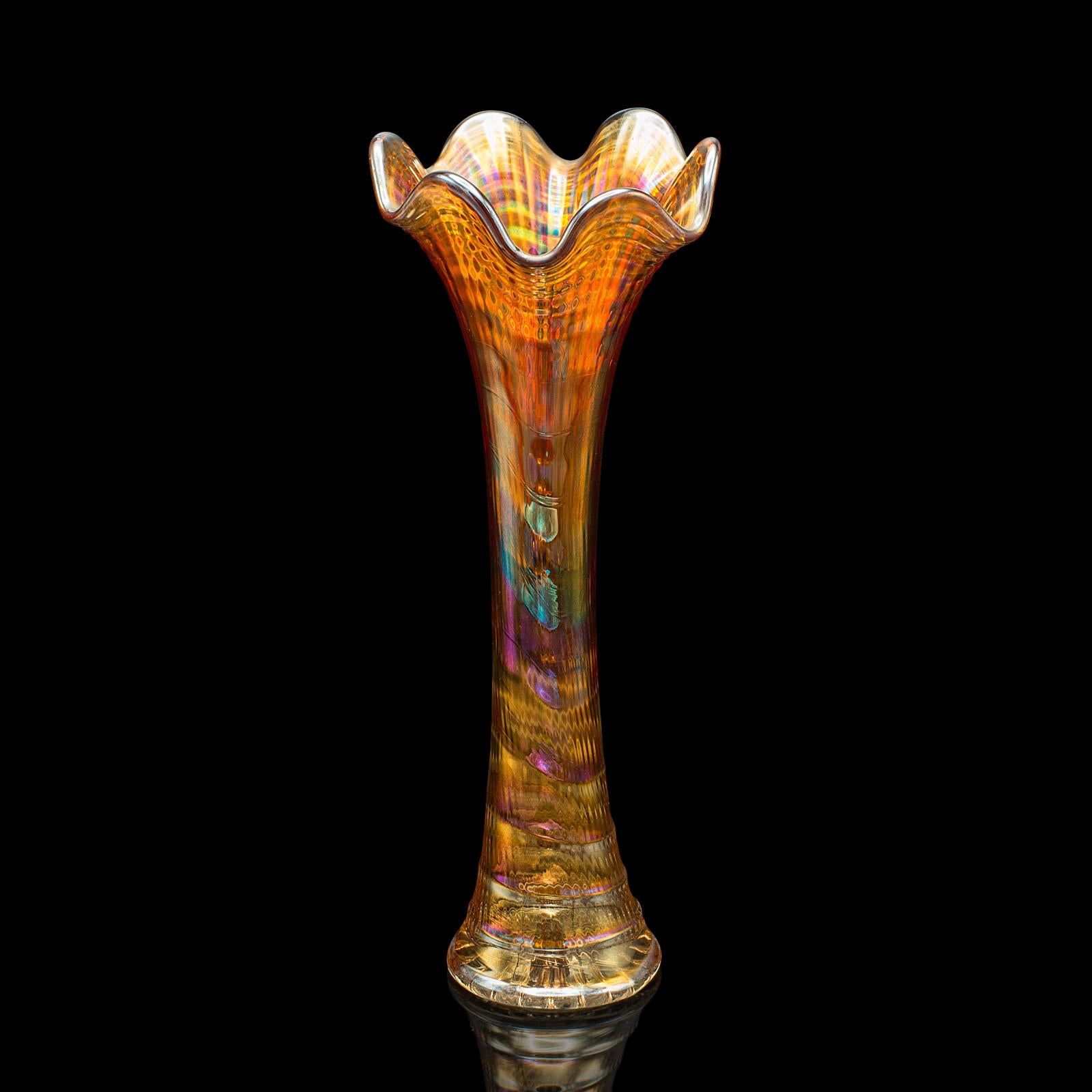 
This is a vintage posy vase. An English, lustre glass stem sleeve, dating to the Art Deco period, circa 1930.

A treat of striking colour with this vibrant carnival glass vase
Displays a desirable aged patina and in good order
Expressive blown