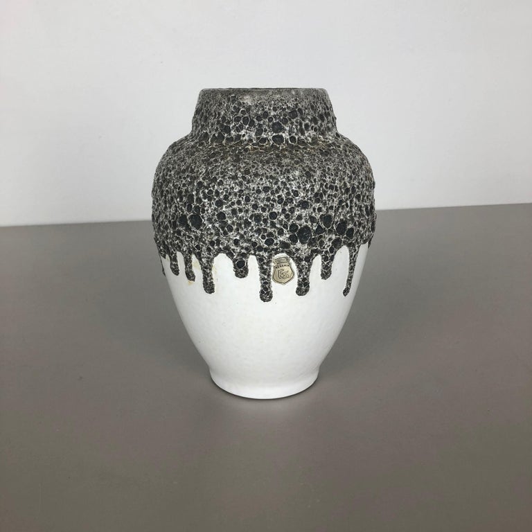Article:

Fat lava art vase 


Producer:

ES Ceramics, Germany (see label)

ES-Keramik J. Emons Söhne, Rheinbach


Decade:

1970s


This original vintage vase was produced in the 1970s in Germany by premium vase producer ES Keramik. It is made of