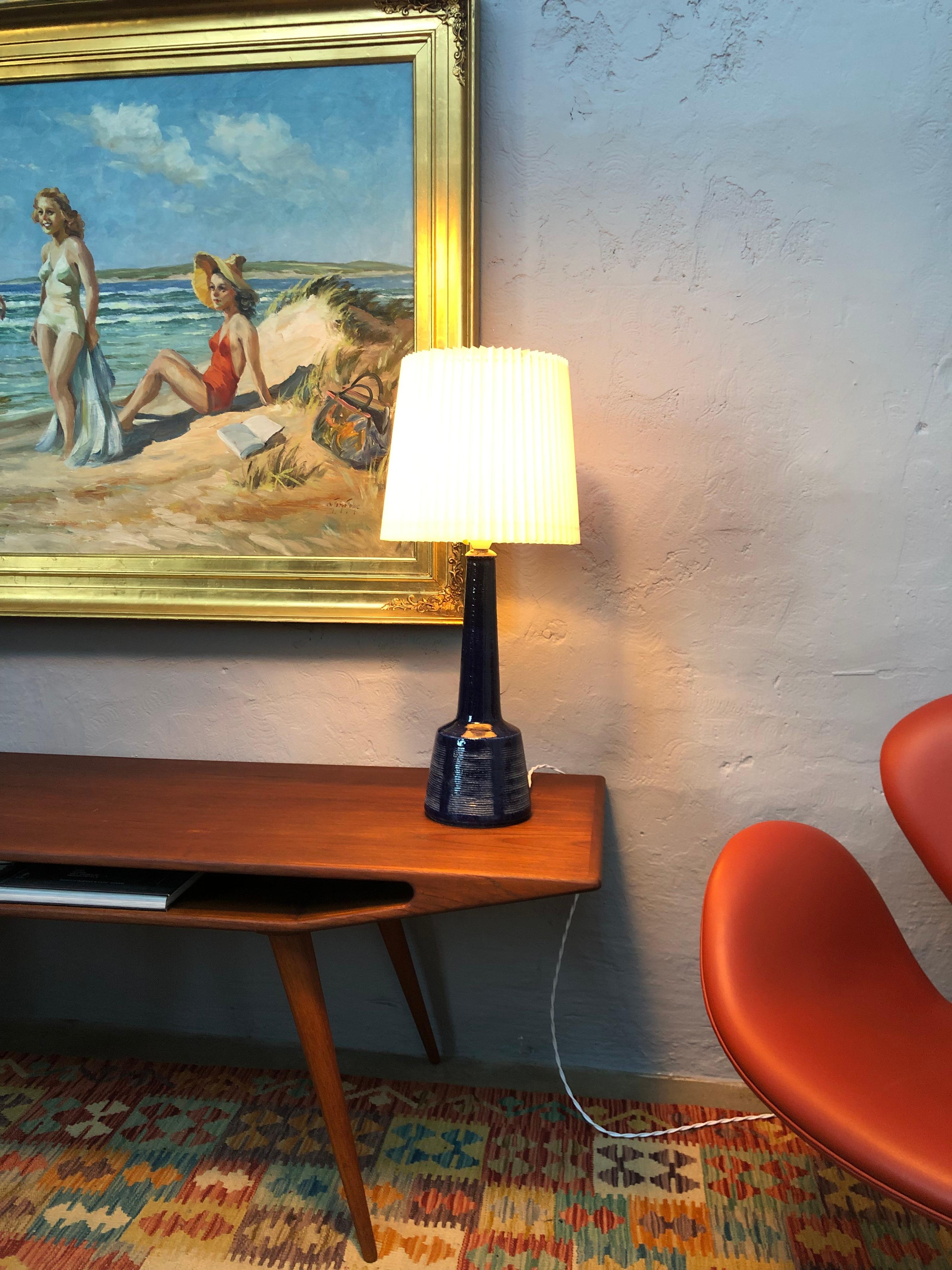 A beautiful midcentury blue pottery table lamp by Per and Annelise Linnemann Schmidt of Palshus. 
With a deep royal blue glaze.
Signed on the base “ Palshus Denmark” 
Original white bulb holder with on/off switch and lampshade holder. 
Can be