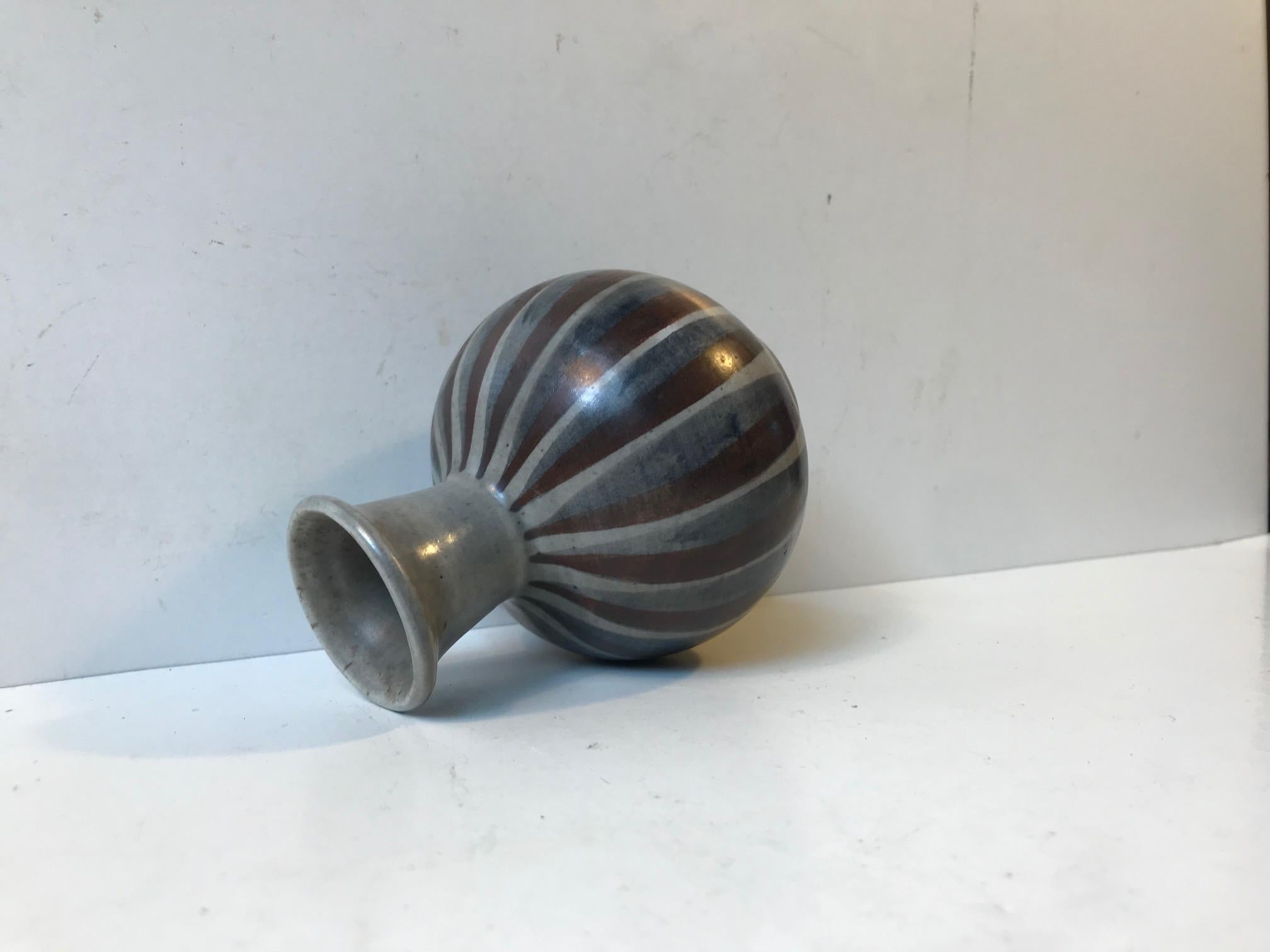Small striped hand glazed ceramic vase designed by the Danish couple and design duo Eva & Johannes Andersen during the 1960s. The vase is signed and numbered to the base.