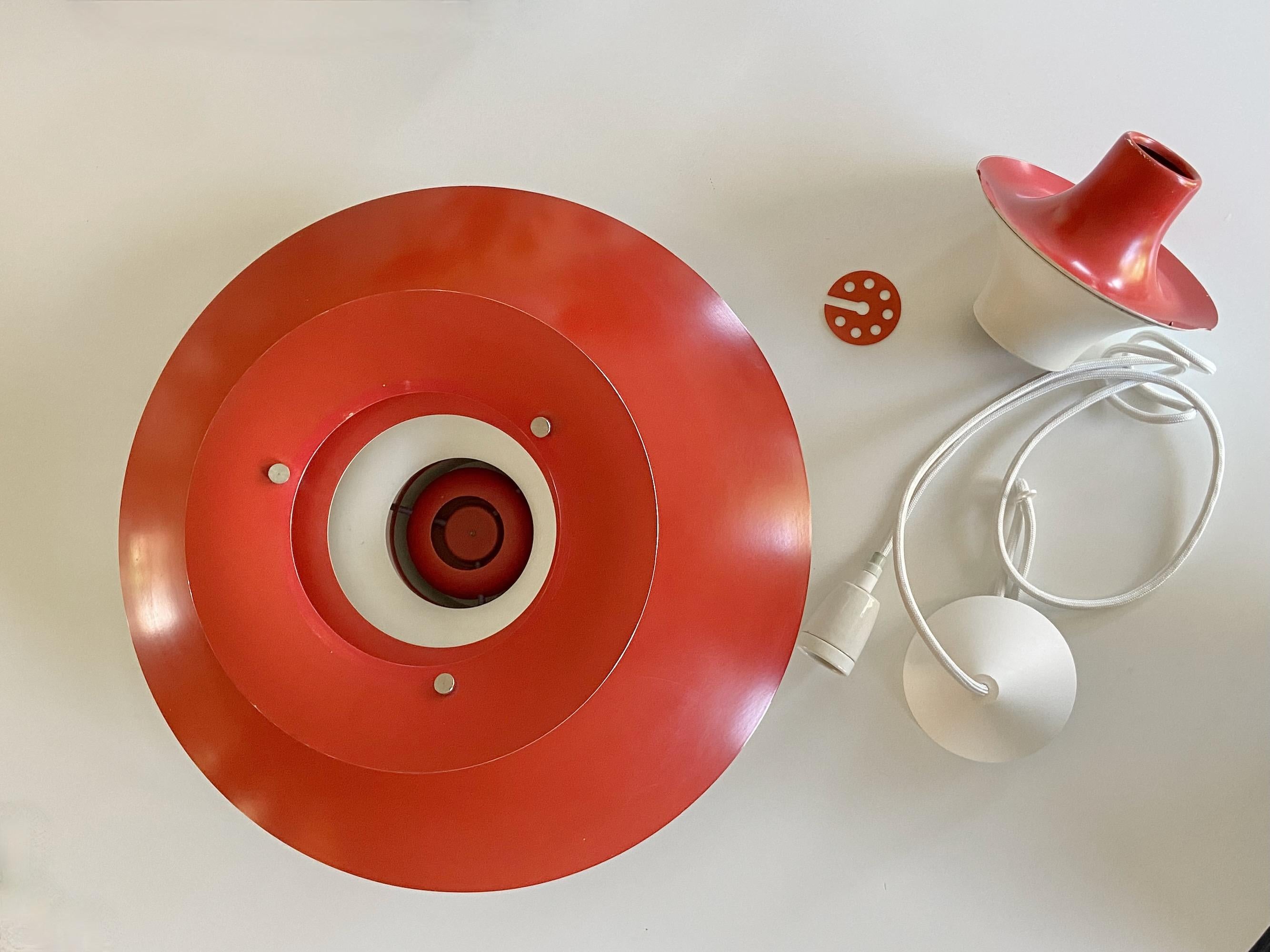 Nice red PH5 pendant lamp design by Poul Henningsen produced by Louis Poulsen, Made in Denmark. This is the nice old Version with the orange circle plate for the socket and long two-part funne . The lamp is in good condition. No parts missing, no