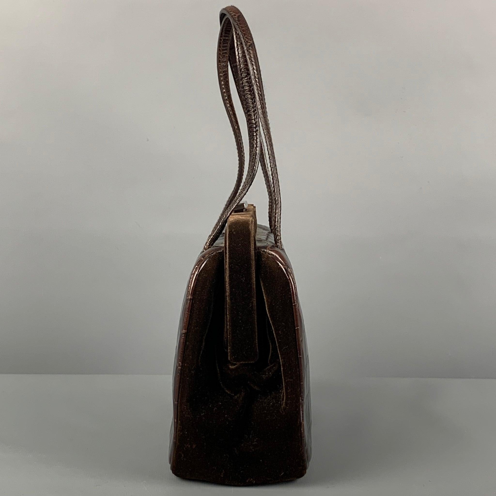 Rare Vintage PRADA mini handbag comes in a brown alligator leather featuring a velvet panel, top handles, inner pocket, and a push open closure. Made in Italy.
Very Good
Pre-Owned Condition. 

Marked:   43 

Measurements: 
  Length: 7 inches  Width: