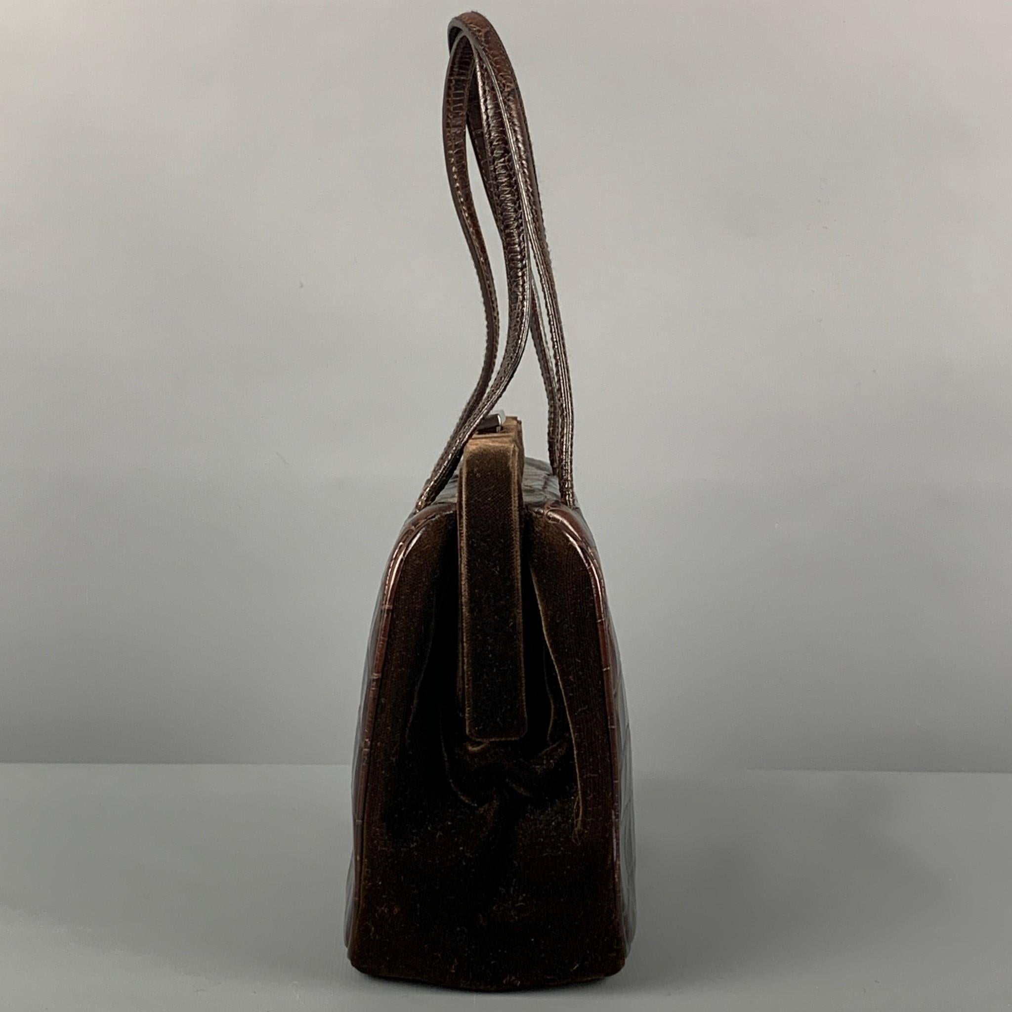 Rare Vintage PRADA mini handbag comes in a brown alligator leather featuring a velvet panel, top handles, inner pocket, and a push open closure. Made in Italy. 

Very Good Pre-Owned Condition.
Marked: 43

Measurements:

Length: 7 in.
Width: 3.25