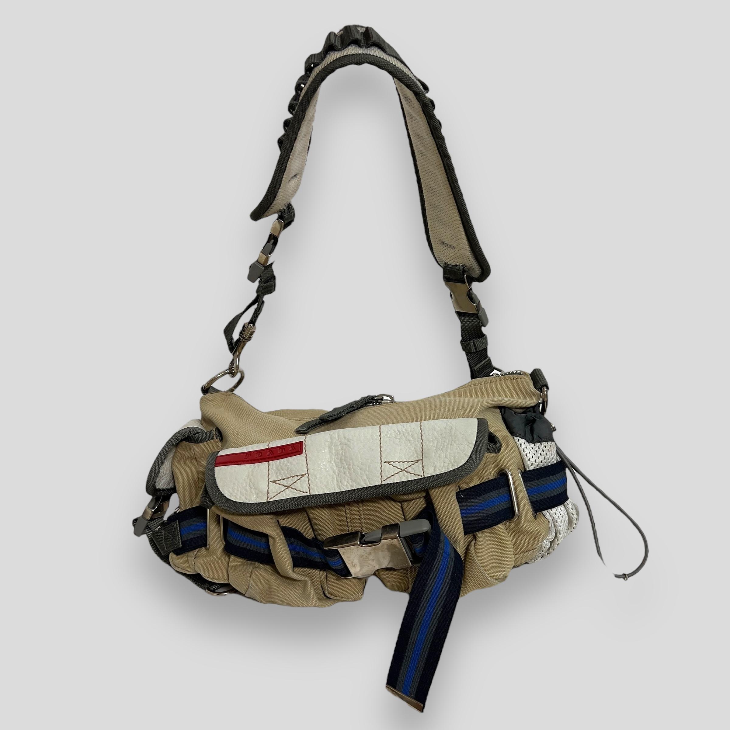 Vintage beige Prada sport bag with parachute detailing. Two pockets on the front and side. Light staining on the right pocket and light stains and signs of use on the outside of the bag. Light stretches on the hardware. Light yellowing on the