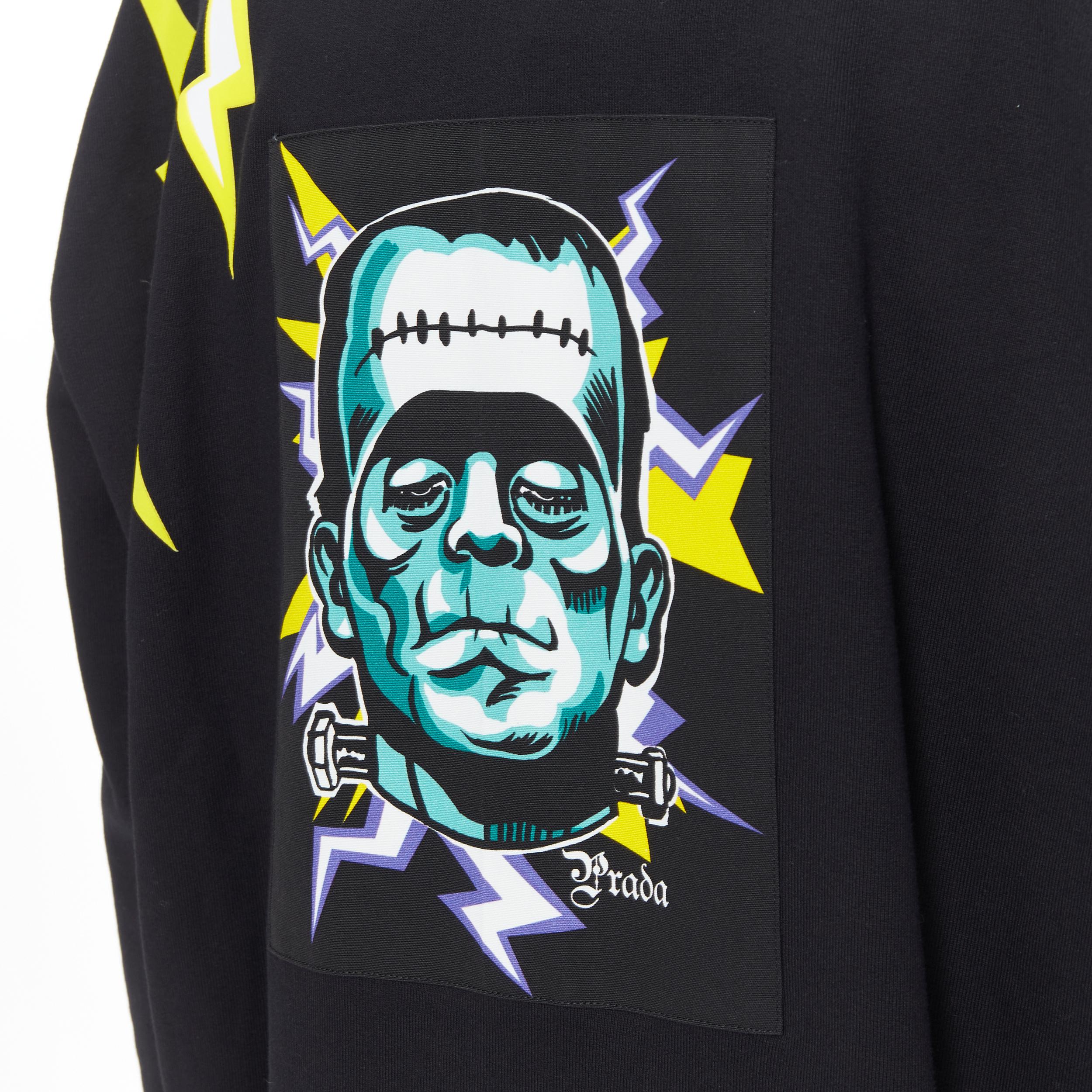 vintage PRADA Frankenstein Lightning bolt patch crew neck pullover sweater XL 
Reference: TGAS/B00480 
Brand: Prada 
Designer: Miuccia Prada 
Material: Cotton 
Color: Black 
Pattern: Other 
Extra Detail: Printed lighning. Frankenstein patch on back.