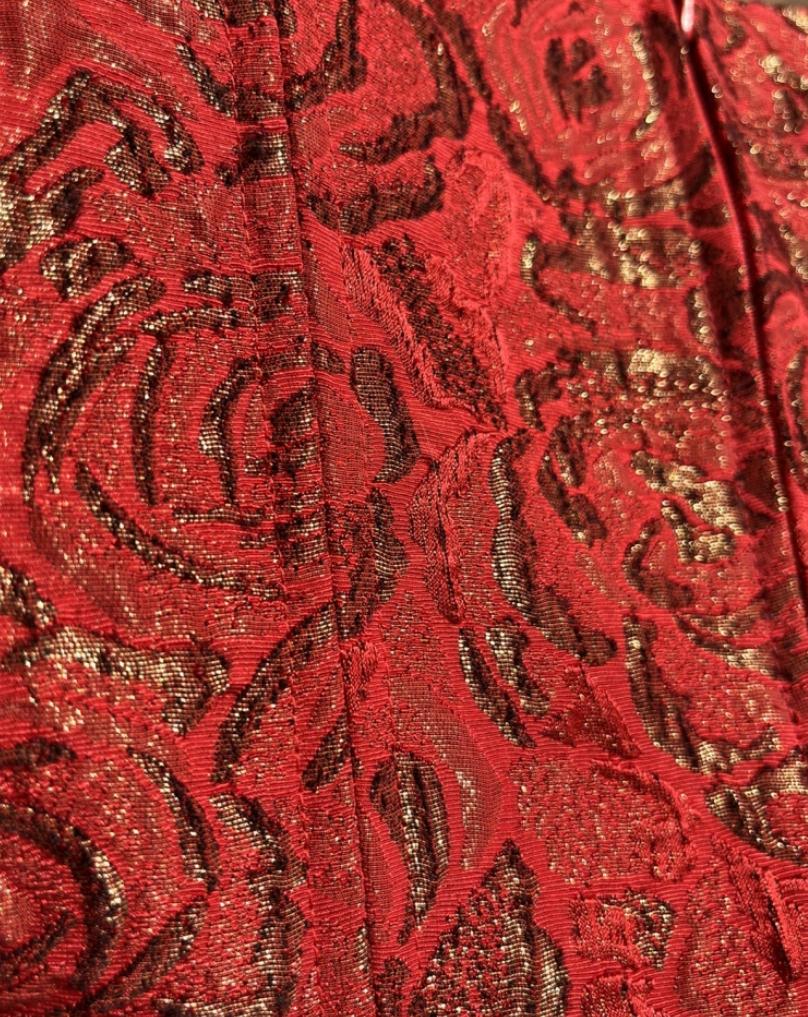 Designed by Miuccia Prada in the late '90s, this rare corset-style top is a standout from the 1999 collection. Crafted in Italy from rich red silk brocade with subtle gold floral embroidery, it’s cut with a square neckline, front zip closure, and a